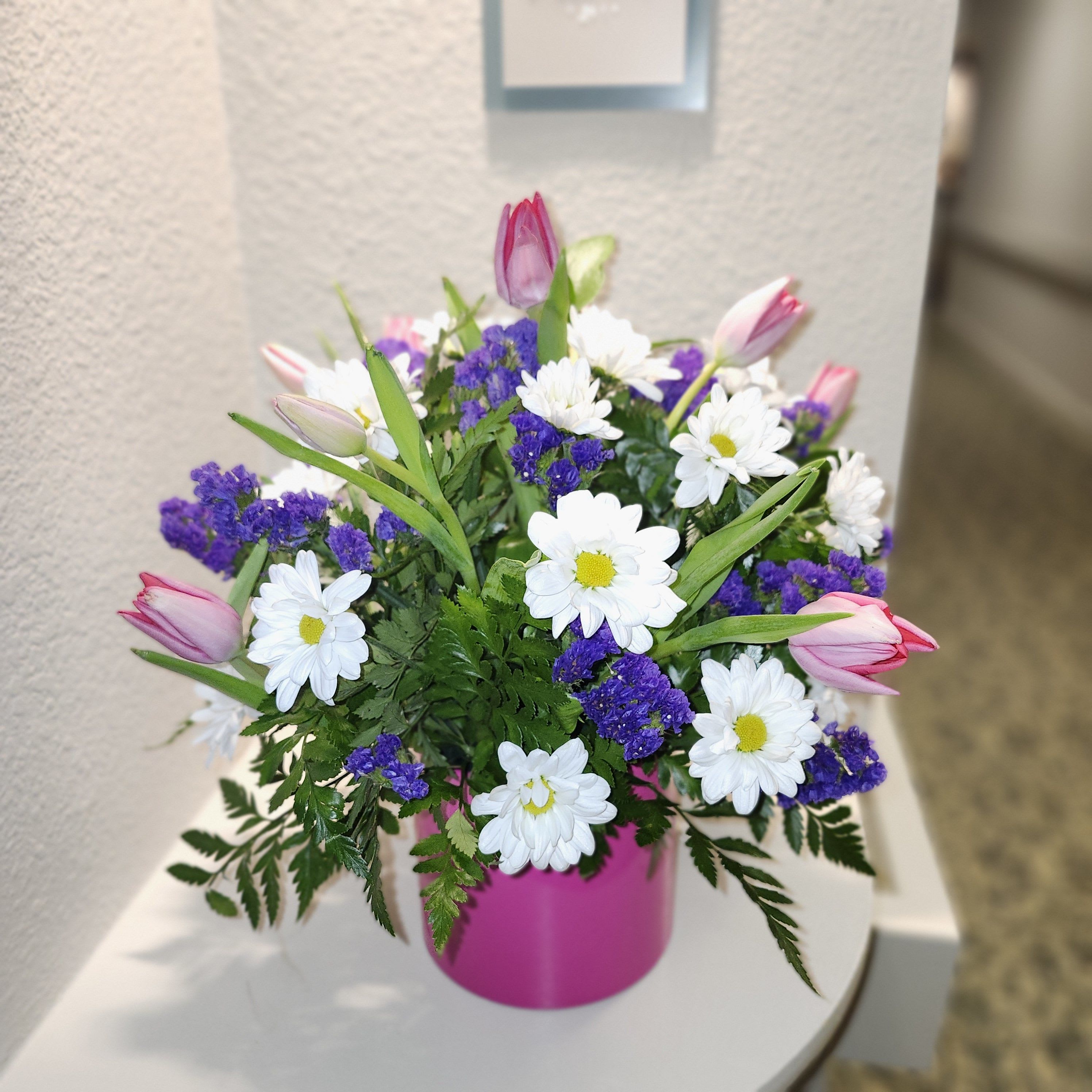 Spring Time Bouquet by Latin Lady Flowers - Embrace the essence of spring with our delightful Spring Time Bouquet, available exclusively for the season. This exquisite arrangement combines the gentle beauty of pastel pink tulips and the fresh elegance of white gerbera daisies. All thoughtfully gathered in a vibrant hot pink ceramic vase, this bouquet is the perfect way to celebrate new beginnings and bring a burst of color to any space.  Whether you're gifting it to a loved one or treating yourself, the Spring Time Bouquet promises to add a touch of springtime joy and cheer to any occasion. Enjoy it while it lasts this season!