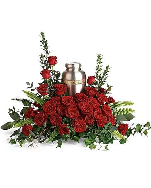 Forever In Our Hearts Cremation Tribute - Elegant red roses and delicate greenery are a breathtaking way to display and honor the cremation urn. Red roses are arranged with myrtle, green ivy, sword fern, silver dollar eucalyptus, and lemon leaf. Arrangement does not include urn.  