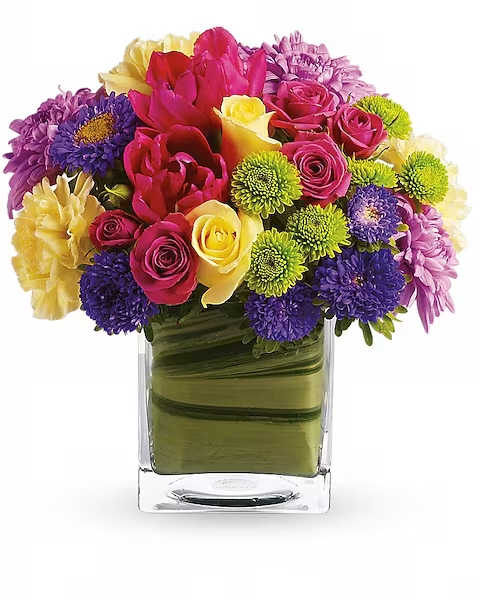 One Fine Day Bouquet - Oh, what a fine day it will be when you have this delightful spring bouquet delivered to someone special. Everyone will delight in the vibrant colors and bountiful blossoms, all thoughtfully arranged in a beautiful leaf-lined vase. Light yellow roses, hot pink spray roses, tulips and gerberas, yellow carnations, green button spray chrysanthemums and lavender cushion spray chrysanthemums are delivered in an exclusive cube vase. You'll have many fine days when you send this beautiful bouquet!