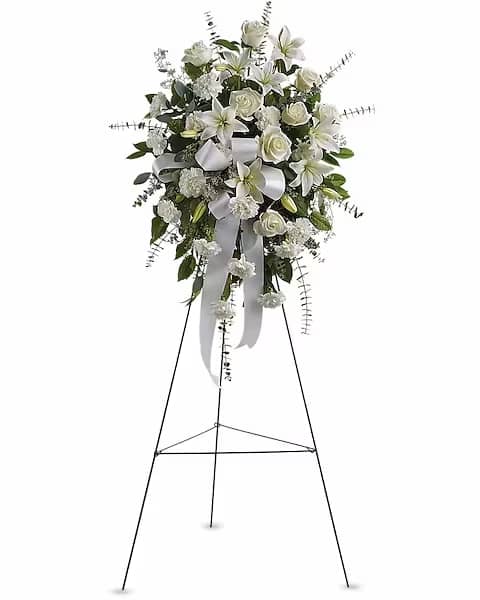 Sentiments of Serenity Spray Sentiments of Serenity Spray - Beautifully simple, this lovely spray of white roses, lilies and carnations decorated with white satin ribbon is a tasteful way to express your sympathy. The elegant spray includes white roses, white Asiatic lilies and white carnations, accented with assorted greenery.