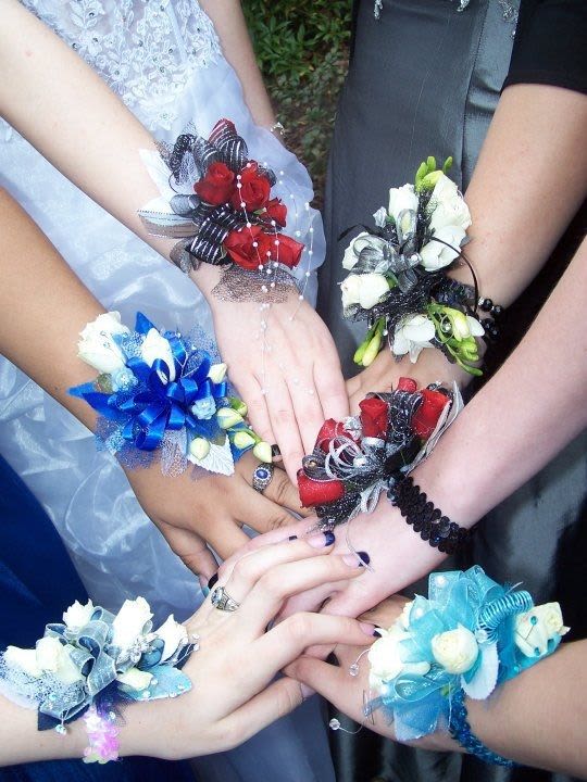 Wrist Corsage Wrist Corsage - Standard spray rose corsage with ribbon. Please specify the color flowers to match your dress, corsage on snap wristband. If you have further customizations, please call the shop at (561) 619-5911 or email us an image @ 123flowers@att.net. We will create a wrist corsage to your specifications.