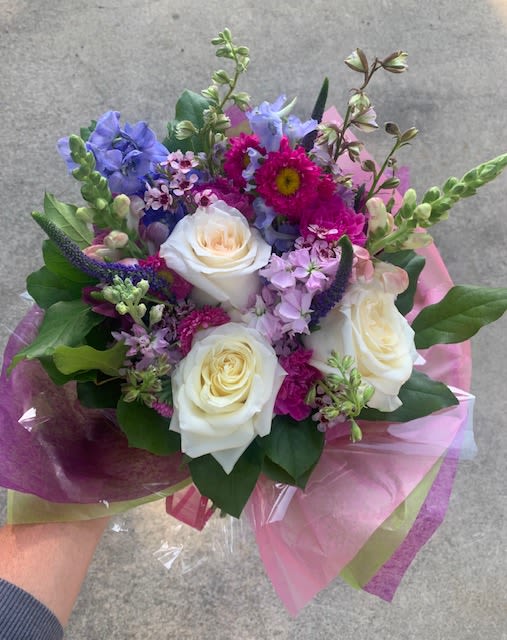 Blessed - A small hand wrapped bouquet consisting of a variety of seasonal blooms in various colors. Each bouquet will be different based on what is currently in our inventory.