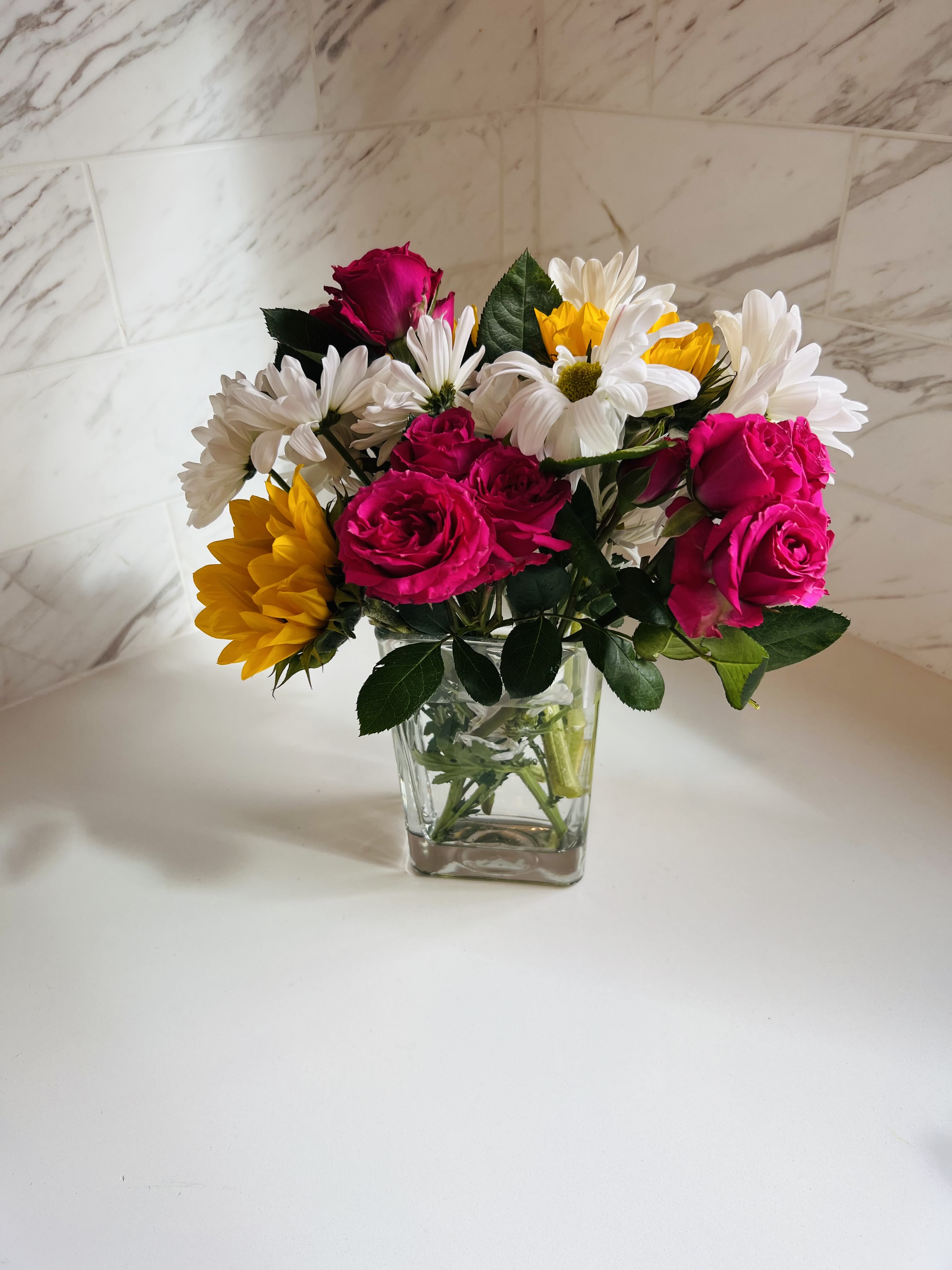 Spring Surprise  - Mixed daisies, sunflowers, and spray roses to make someone smile.