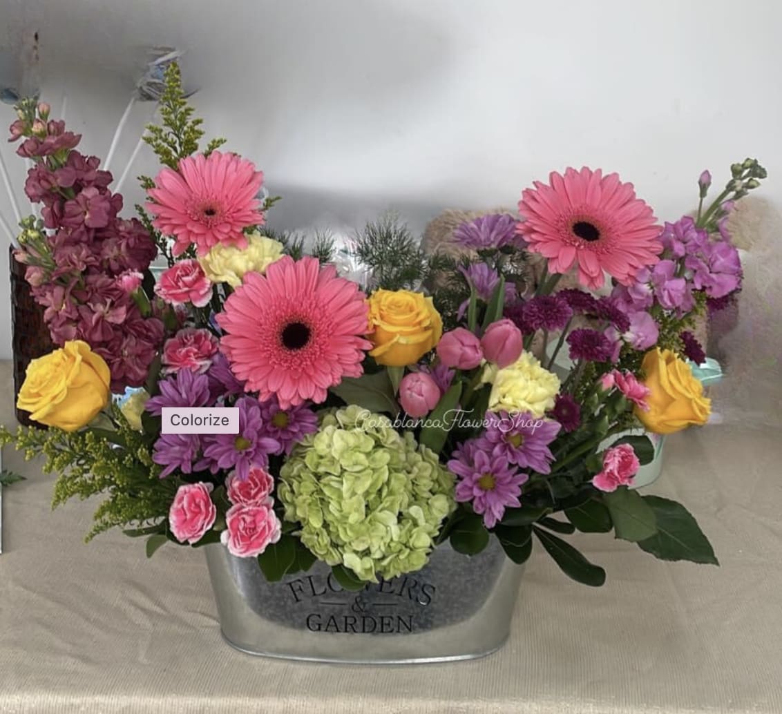 Sunny Garden Sunny Garden - vibrant colors, sweetly scented blooms... and that’s why we’ve captured it all in one charming basket!