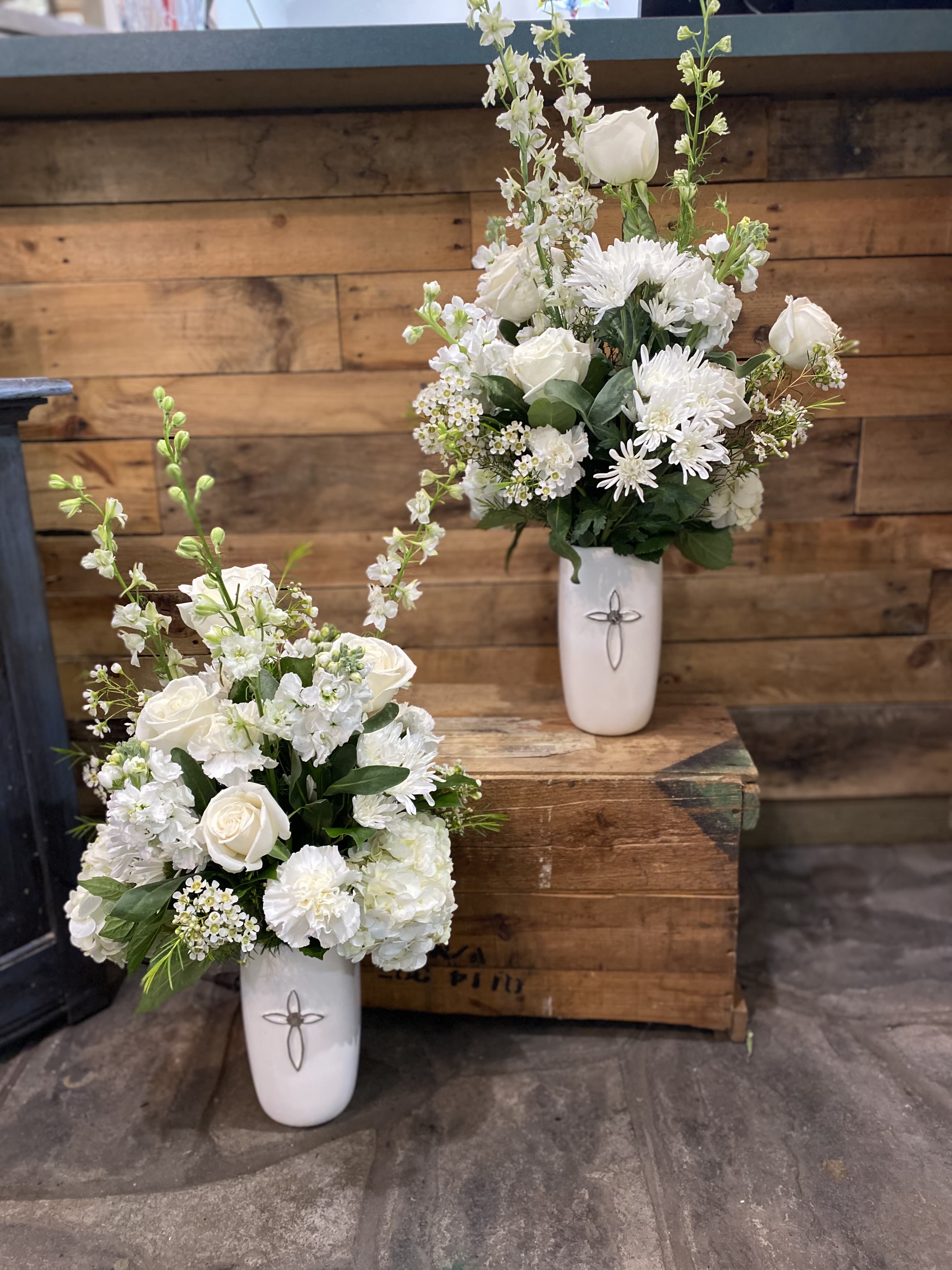 Eternal Blossom - This is an elegant white arrangement that includes some wax flower, white Ecuadorian roses, and some hydrangeas, and more beautiful white flowers.