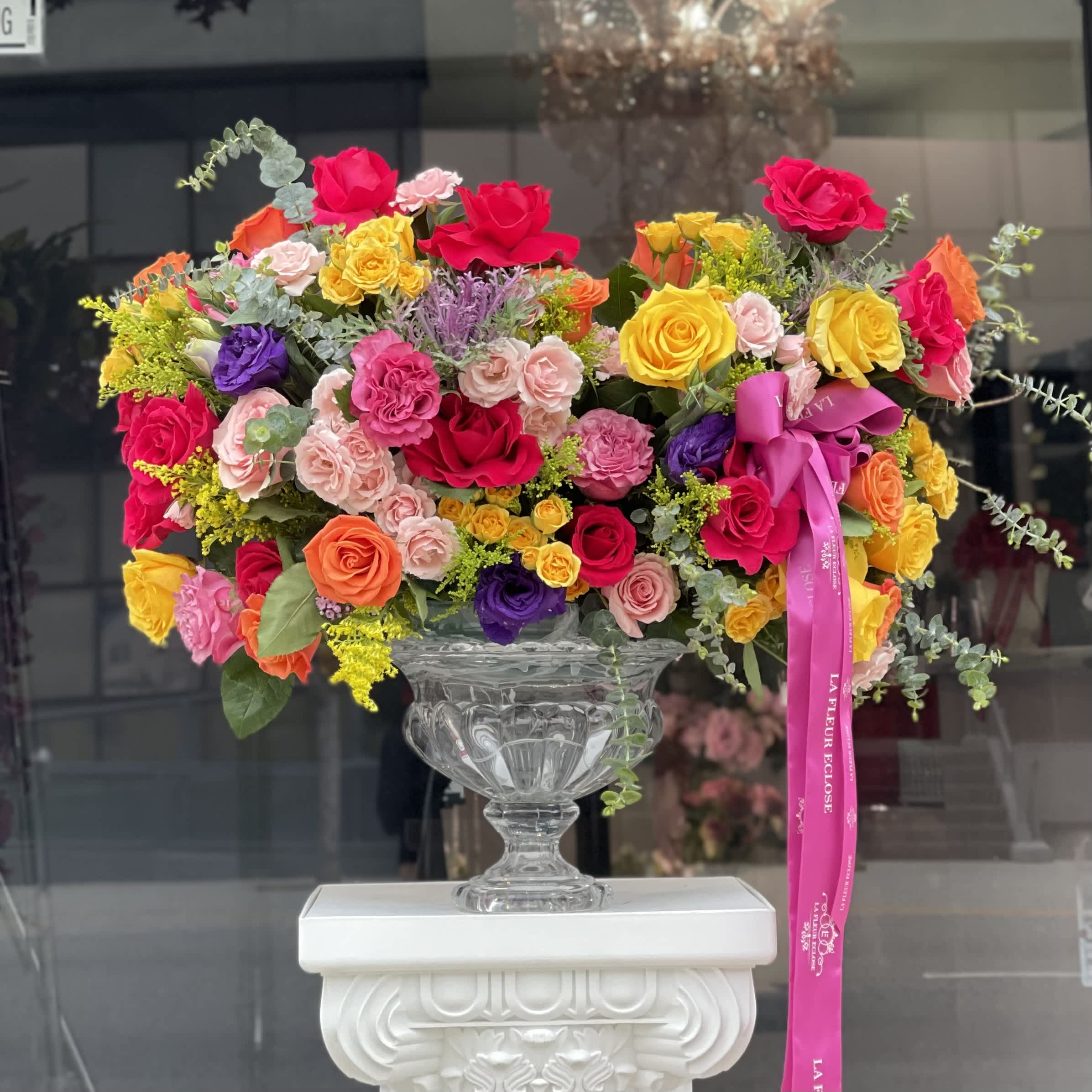 Bring The Beauty  V - Bring the beauty of Spring indoors with this stunning composition of colorful blooms in our glass vase, which is the perfect complement to their beauty. The delicate hues of orange , pink , yellow ,and purple will lift your spirits and brighten up your day.  