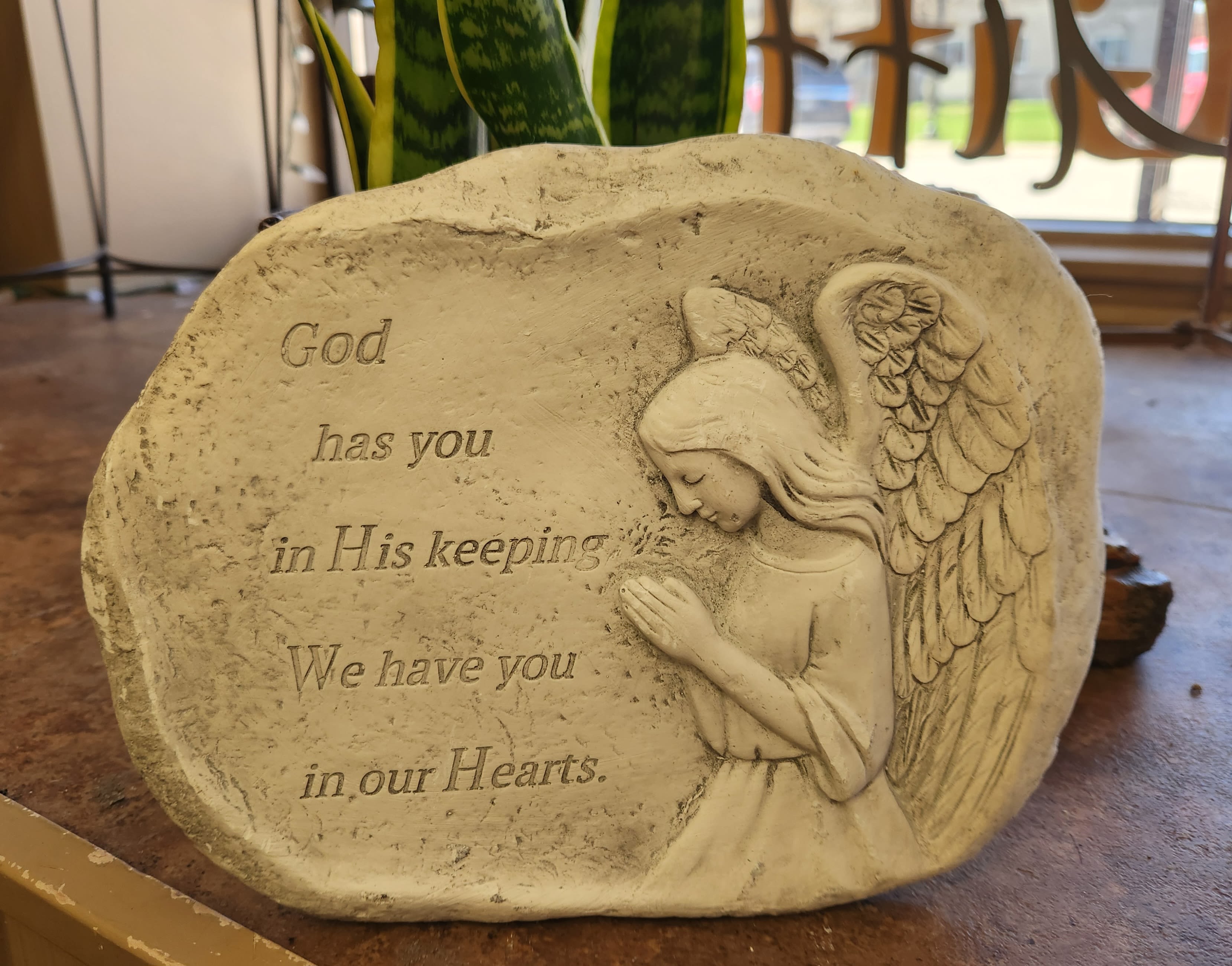 God has you in his keeping stone God has you in his keeping stone - Resin angel stone to put outside in memory of your loved one. Saying - God has you in his keeping, we have you in our hearts.