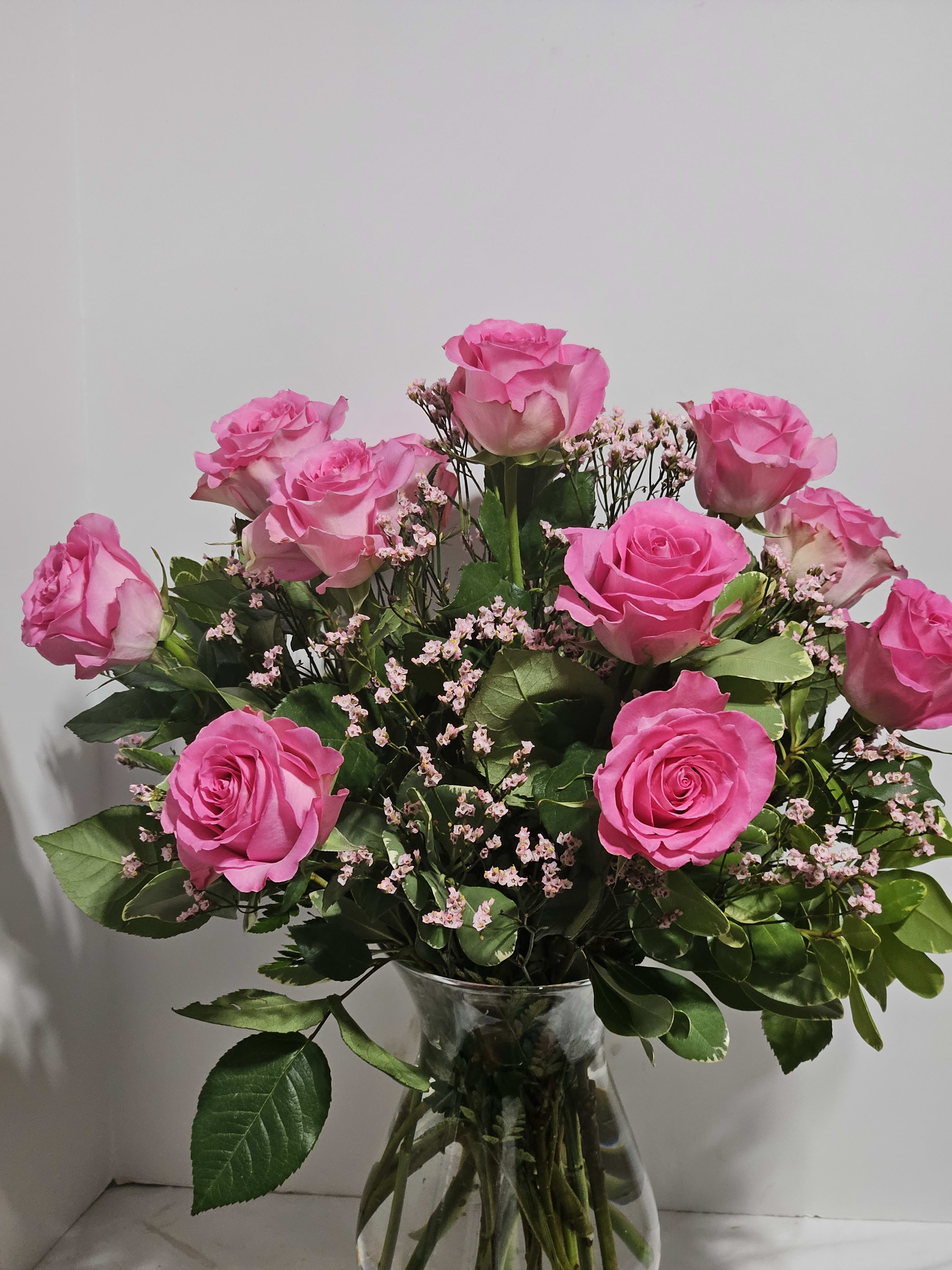Rose Elegance Long Stem Pink Roses - Long-stem pink roses are just the gift when you want to express yourself with all the grace, sophistication and elegance they deserve--and more. Give fresh romance and passion with this beautiful, hand-crafted arrangement of  long-stem pink roses. Our professional designers select the finest, freshest long-stem pink roses and arrange them by hand with fresh gypsophila in a classic glass vase.  Since each arrangement is hand-designed colors, varieties, and container may vary due to local availability. Regular is 12 Roses Deluxe is 18 Roses Premium is 24 Roses