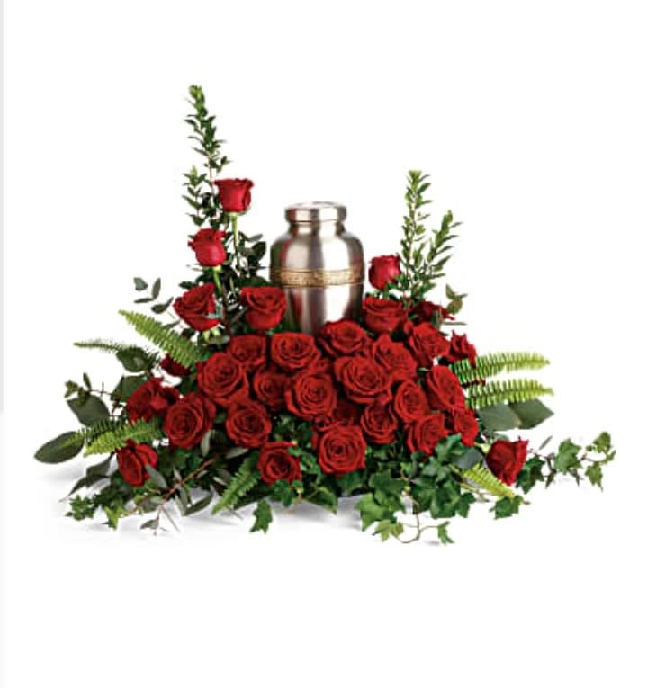 Forever In Our Hearts Cremation Tribute Forever In Our Hearts Cremation Tribute - An elegant tribute to a rich, radiant life, this breathtaking bouquet of resplendent red roses and delicate greenery makes a beautiful presentation of the cremation urn. Red roses are arranged with myrtle, green ivy, sword fern, silver dollar eucalyptus, and lemon leaf. Arrangement does not include urn.