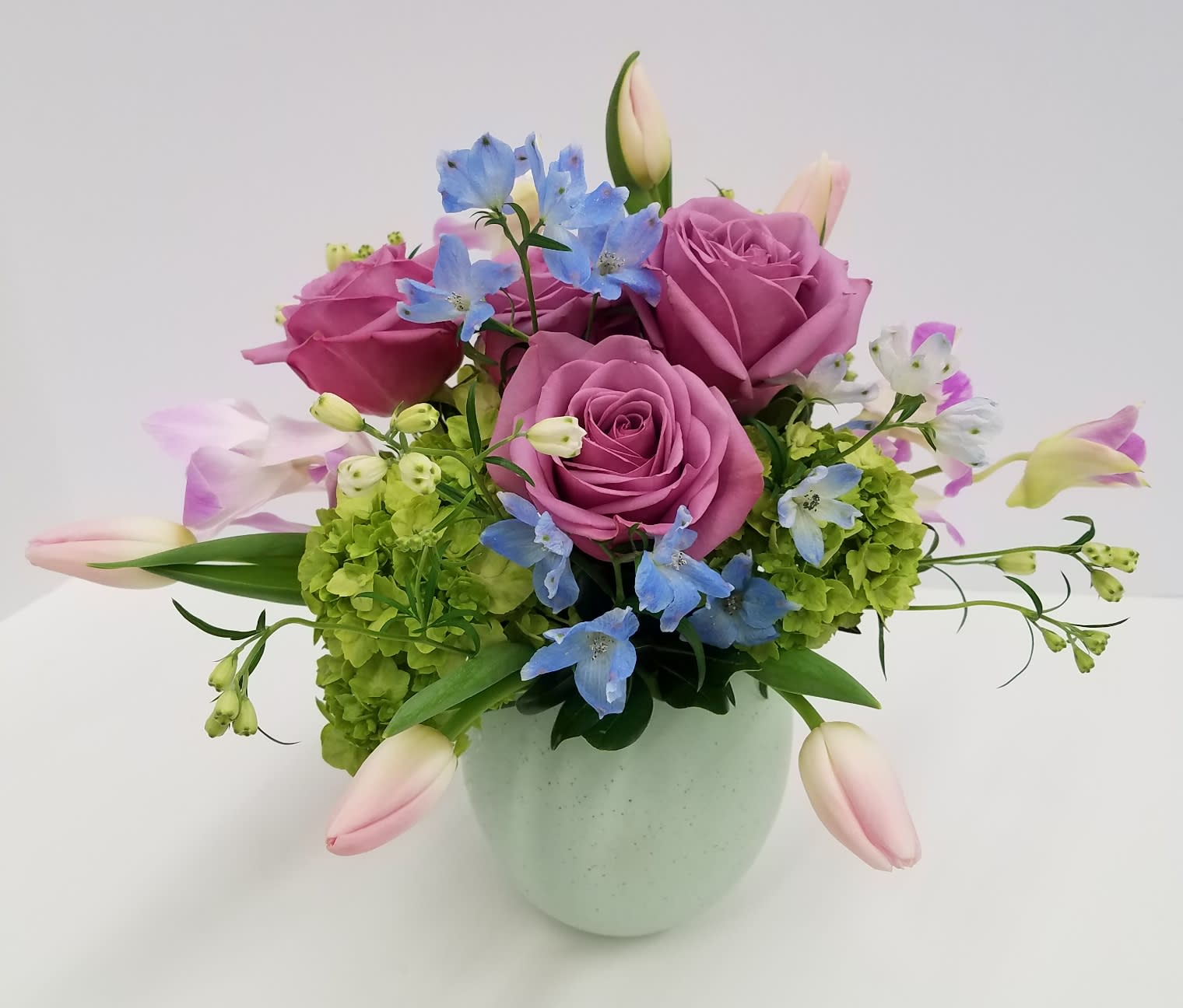 Hatch Into Spring Hatch Into Spring - An adorable ceramic egg filled with a delicate mix of flowers including hydrangea, roses, delphinium and dendrobium orchids.