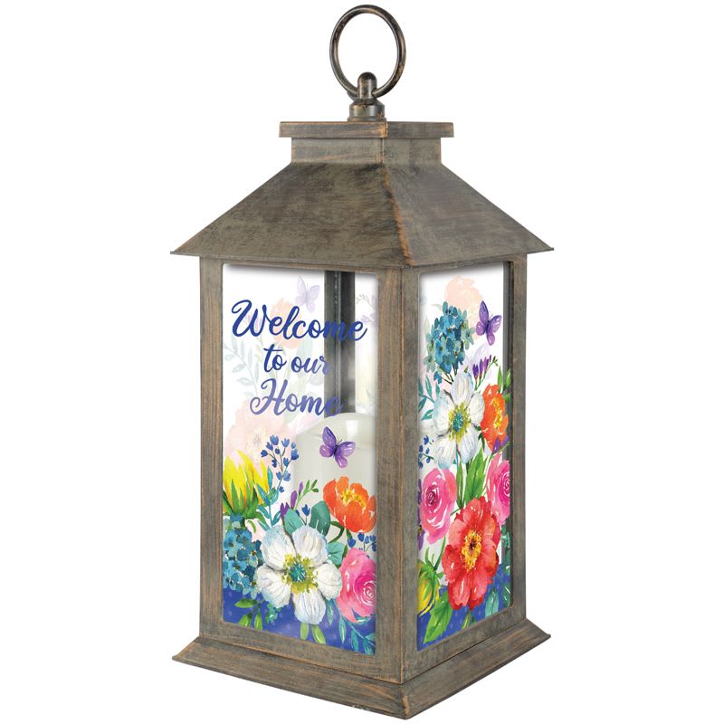 &quot;Welcome to Our Home&quot; Floral Lantern - The &quot;Welcome to Our Home&quot; lantern is made of weather friendly materials and UV printed glass. It includes a flameless LED candle with a built-in automatic timer: 6hrs ON/18hrs OFF (3 AAA batteries are included). It is suitable for hanging or free-standing use.  Height: 14&quot;