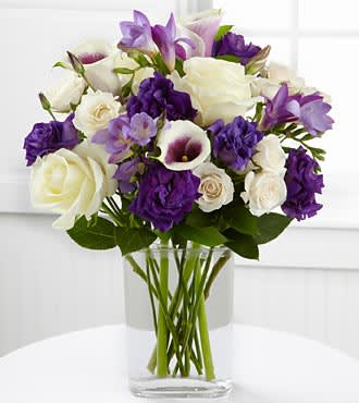 Deep Purple Deep Purple - This exquisite contemporary arrangement will enthrall with it's interplay of purple, white and lavender. Picaso calla lilies, pure white premium Ecuadorean roses, purple lisianthus and lavender stock are stunning in a clear contemporary tall vase. Pure luxury! (Please give us at least one day's notice, as flowers such as Picaso Calla Lilies are not usually kept on hand, but we are happy to get them for you)!