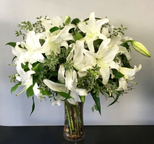 Casa Bloom - WeHo Casa Bloom - WeHo - Casa blanca lilies make up this grand arrangement. It's looks aren't the only aspect that's amazing, the smell is incredible too! It stands approximately 28'' tall and 20'' wide. Make sure to order the premium version to get an eye popping arrangement.