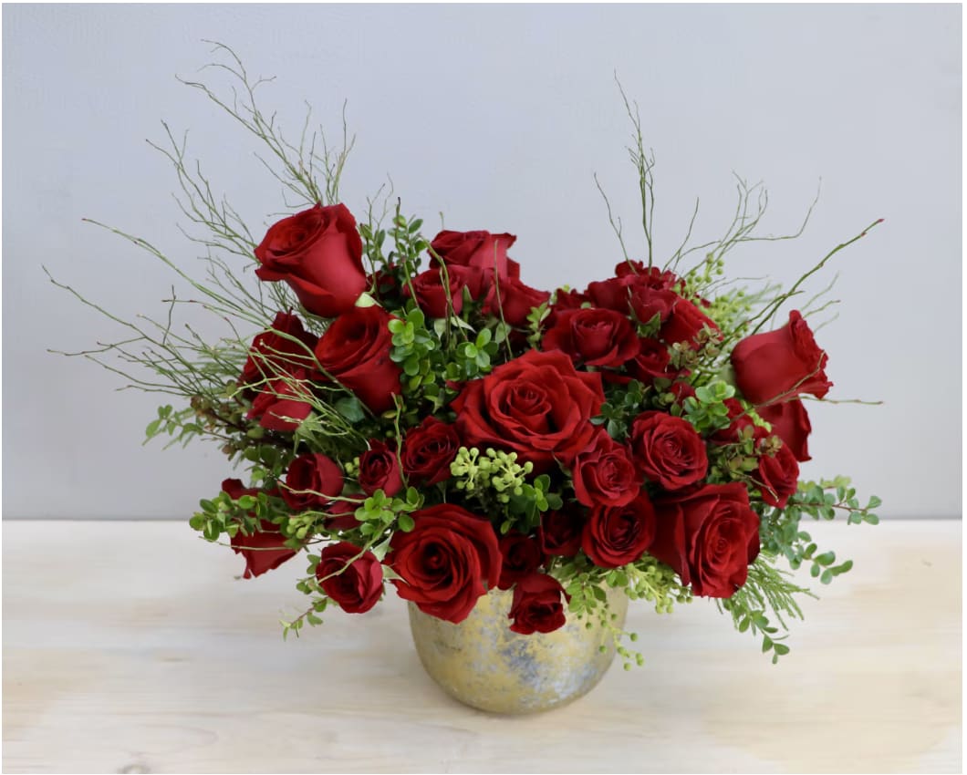 Gold Rose Gaden - WeHo Gold Rose Gaden - WeHo - This design brings together spray and large red roses in a golden vase. These romantic roses are complimented with lush greenery. This arrangement is available in one size, about 12"x12."