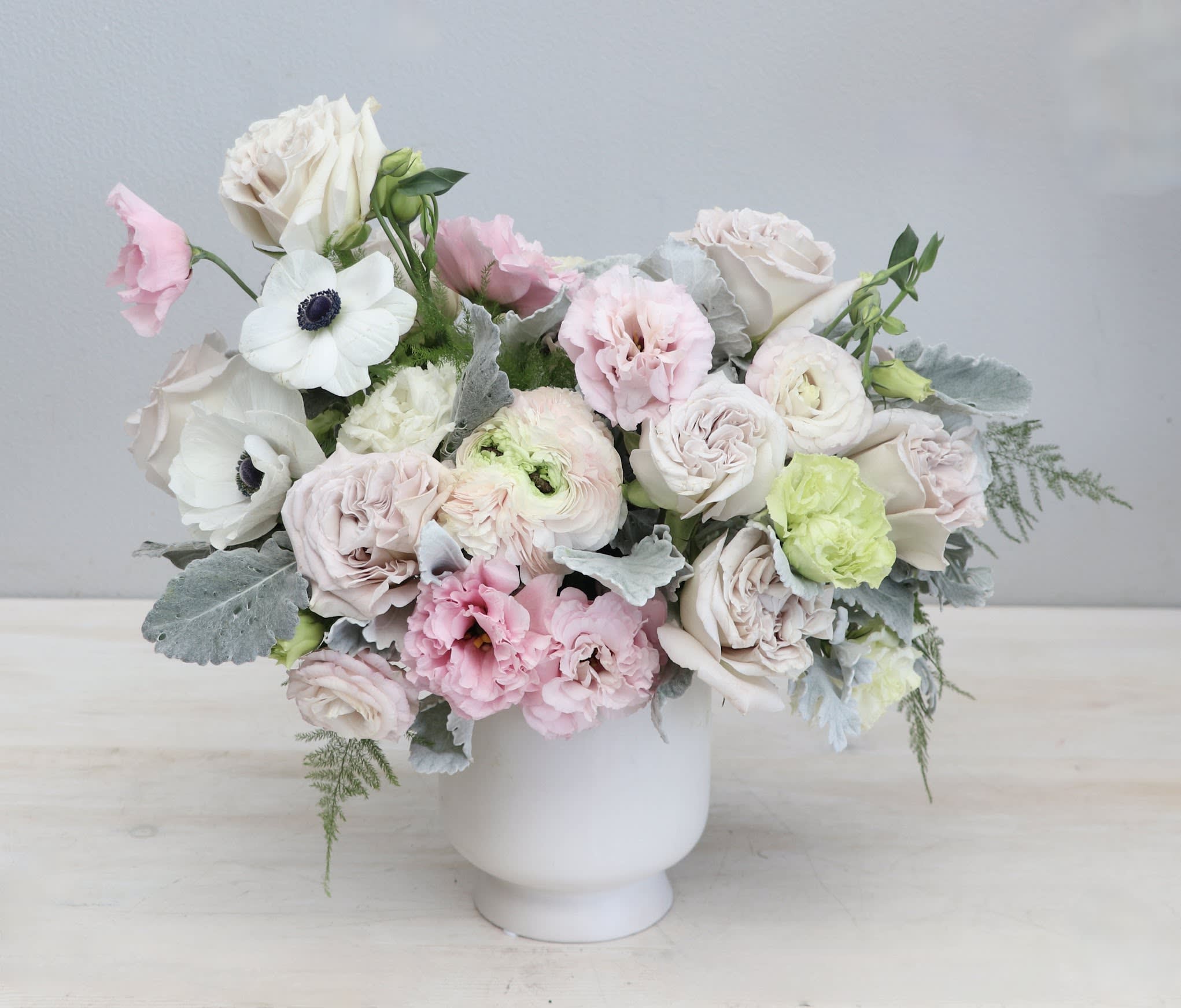 Roses and Pastels - WeHo Roses and Pastels - WeHo - This stunning floral arrangement features a beautiful blend of pastel colors, with delicate roses, ranunculus, lisianthus and other charming blooms creating a breathtaking display. Soft hues of pinks and whites come together to create a delicate and romantic atmosphere, perfect for weddings, anniversaries, or any special occasion.