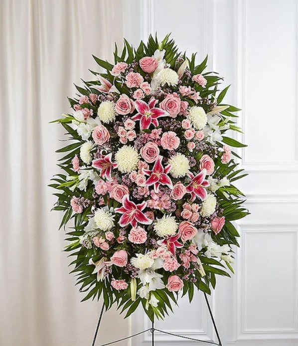 Pink and White Standing Funeral Spray - Standing spray arrangement with red roses and Matsumoto asters, pink Stargazer lilies, white Peruvian lilies (alstroemeria), carnations and football mums; accented with spiral and seeded eucalyptus, baby’s breath and assorted greenery.