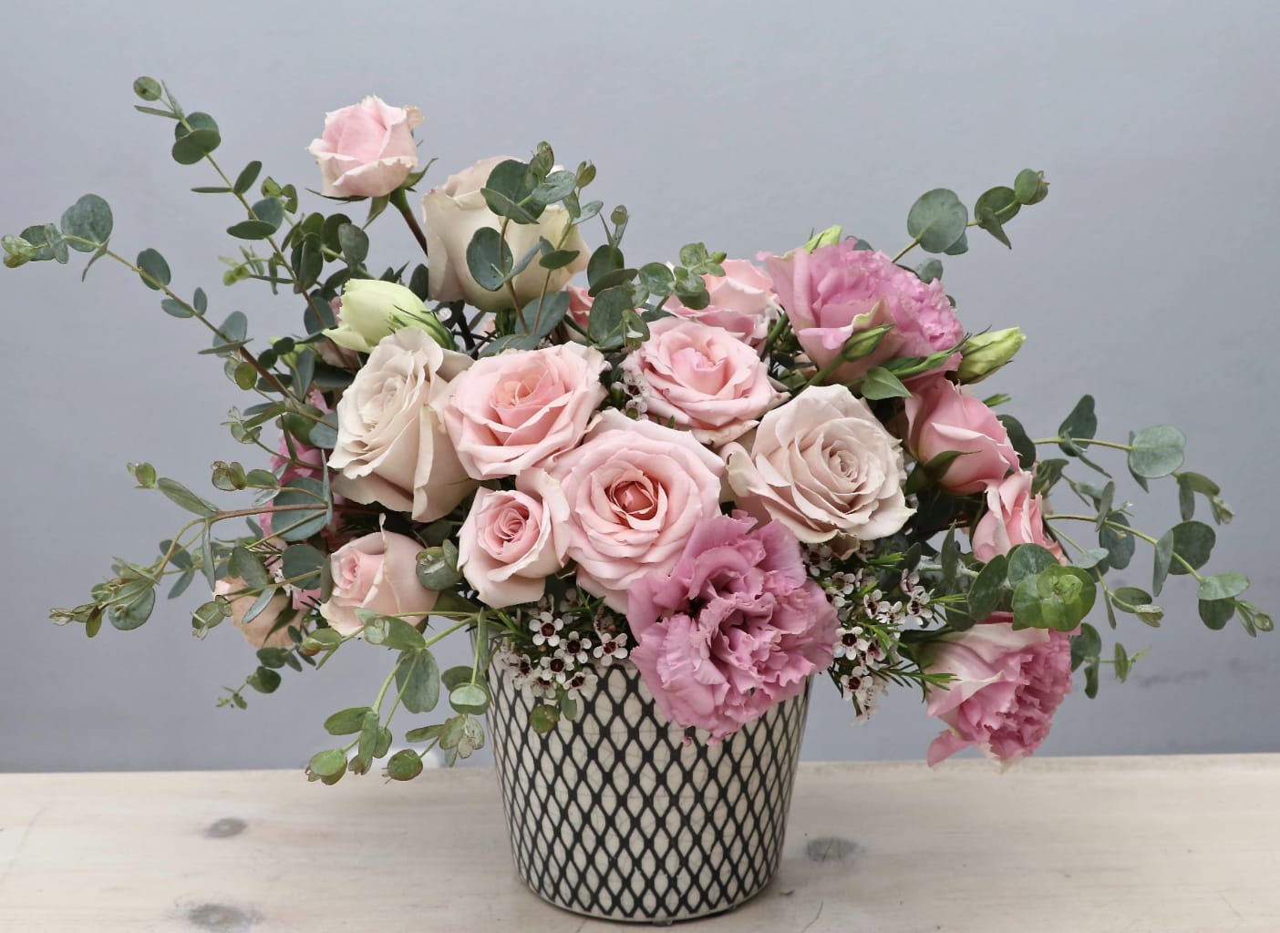 Pink Sunshine - LA - This arrangement really is a spark of sunshine. Sure to make any recipients smile as soon as they receive it. Full of pink roses, lisanthus, and eucalyptus.  Standard size measures approximately 10x10'' make sure to upgrade for a larger size and a bigger impression. 
