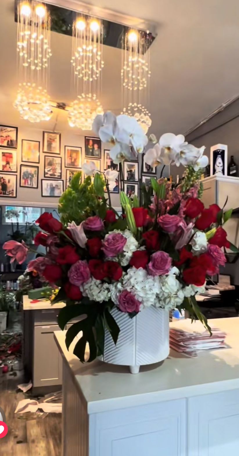 Love in full bloom - This combination of roses, pink and white bell of Ireland orchid plants snapdragons with an exclusive touch of elegance make this arrangement, the most beautiful one for any special location or celebration