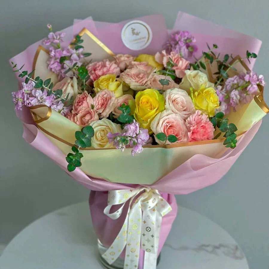 Lemonade Lemonade - Quench your thirst for beauty with our Lemonade bouquet, a vibrant and refreshing blend of yellow and pink roses, hydrangeas, stock, eucalyptus, and lush greenery. This delightful arrangement captures the cheerful essence of a sunny day, bringing a burst of color and fragrance to any space. Perfect for brightening someone's day, celebrating a special occasion, or simply adding a touch of sunshine to your surroundings, the Lemonade bouquet is the perfect way to spread joy.