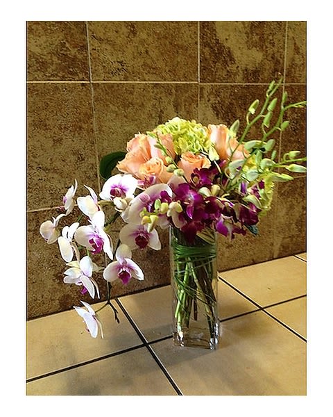 Luxury Orchids Duo - A combination of phalenopsis orchids and Dendrovium Orchids with Roses and touch of Hydrangeas in a tall cylinder glass container, Simple and elegant