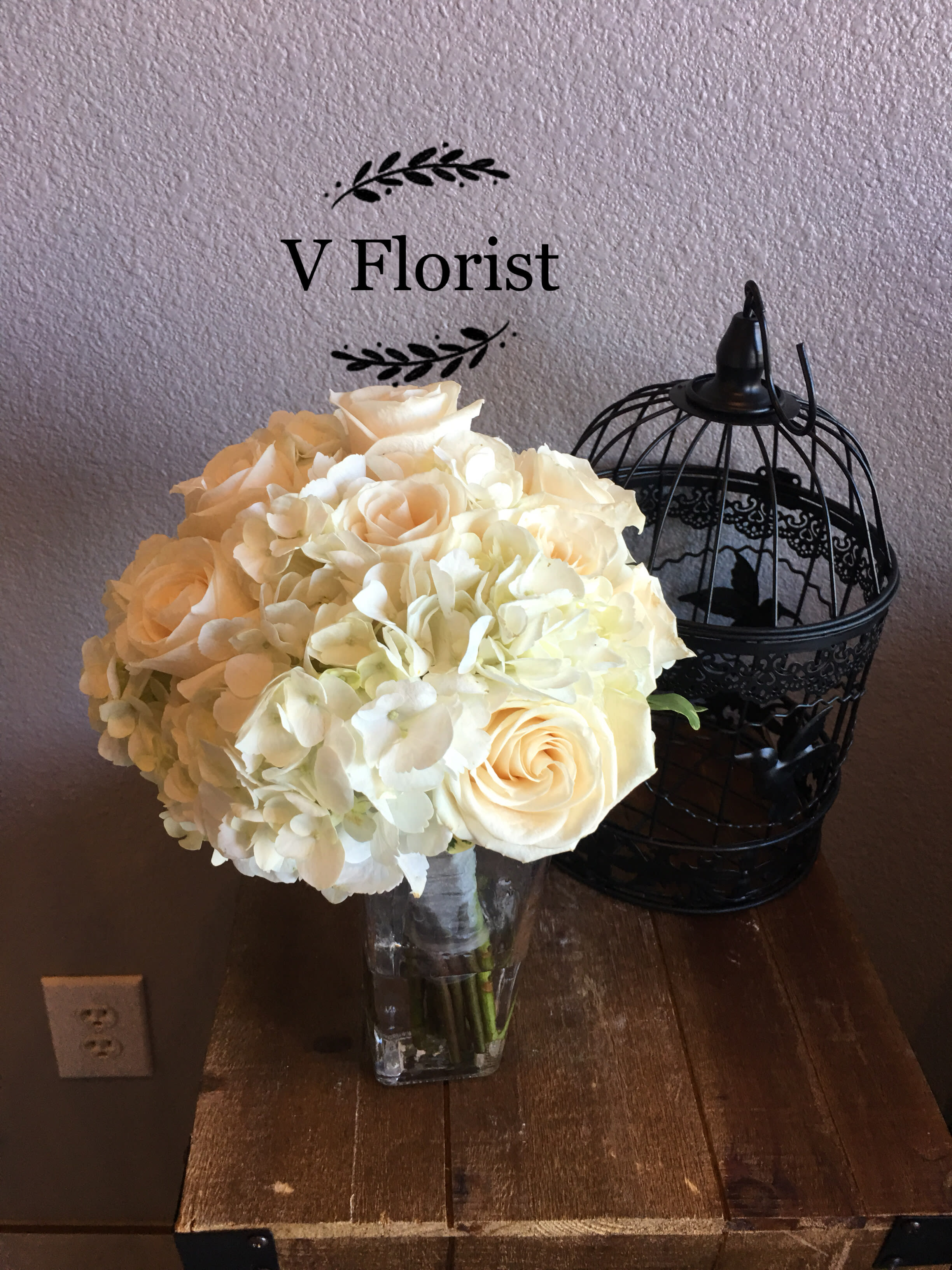 All White Bouquet (style 2) - On your wedding day, nothing is more classic or elegant than an all-white bouquet. We’ve filled ours with White hydrangea and white roses, and finished it off with a matching white satin ribbon. Beautifully hand-arranged by our team of expert florists, it’s as perfect a pairing as the happy couple. Stunning hand-designed bouquet of white hydrangea and white roses accented with a crisp white satin ribbon All of our wedding flowers are hand-designed and arranged at a local florist to ensure they arrive looking their best on the big day Our florists select the freshest flowers available so floral colors and varieties may vary Orders must be placed two weeks in advance to allow for processing