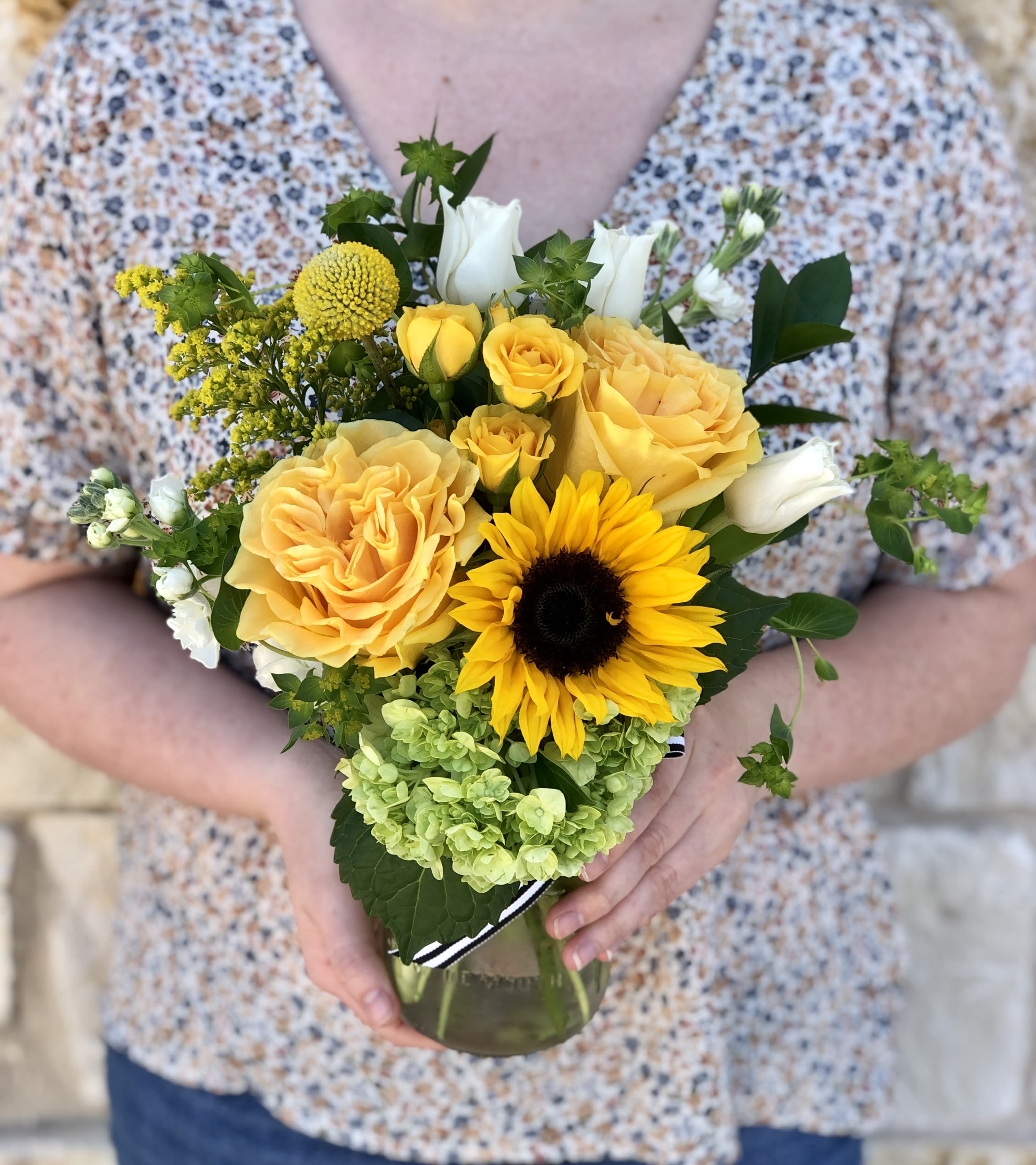 Sunny Bloom Jar - A cheerful garden mix of seasonal Yellow and White blossoms. Arranged in our clear glass bloom jar. Overall design is approximately 12&quot; tall.  Floral varieties may vary but will be of similar quality and style.  