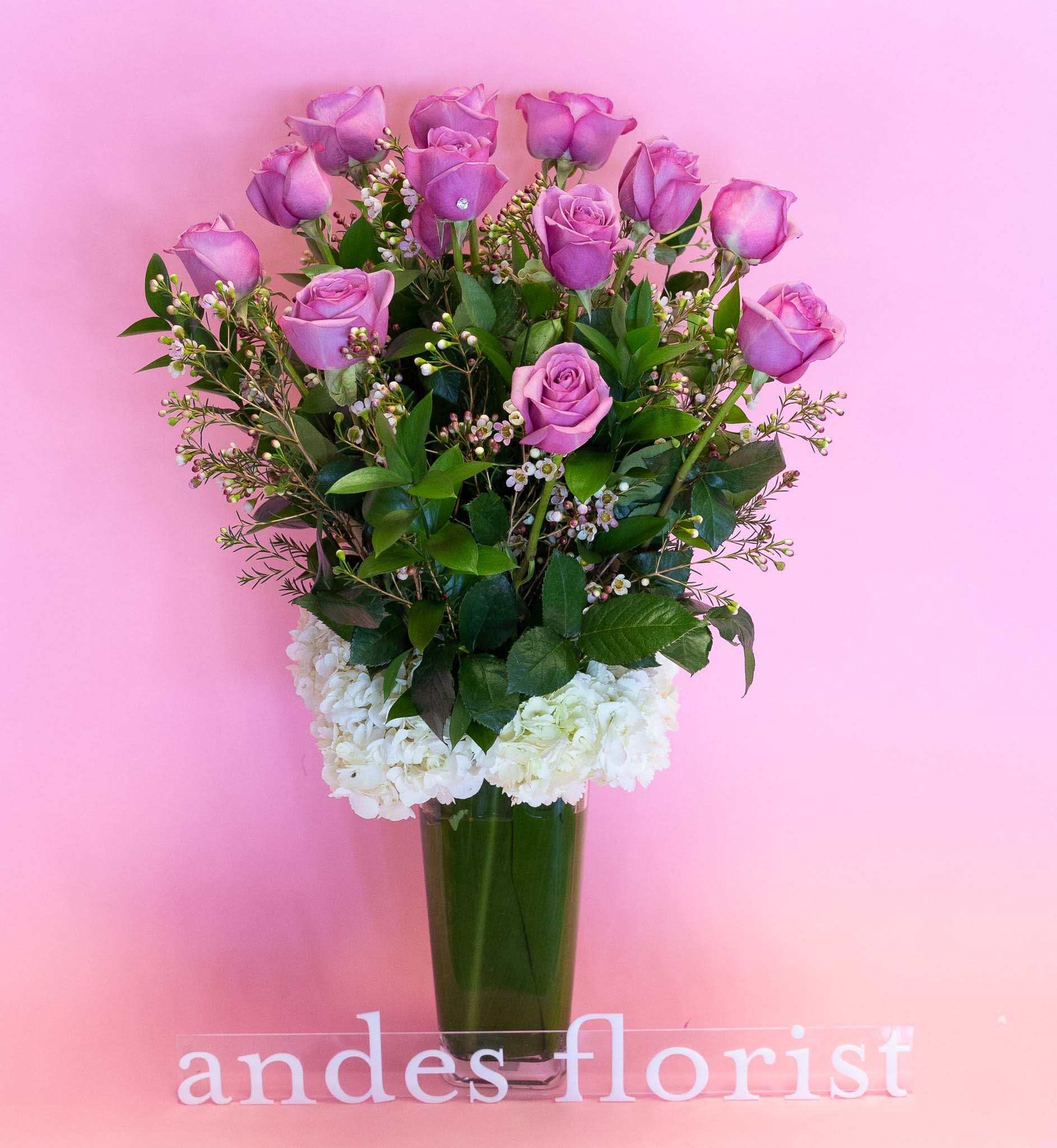 Lana - Long Stem Lavender Roses in a Tall Vase - Imported Ecuadorian roses in a tall vase. We decor the bottom with hydrangeas for an abundant look. Mixed with exotic greens and filler flowers, this is our most popular item! *available in different colors