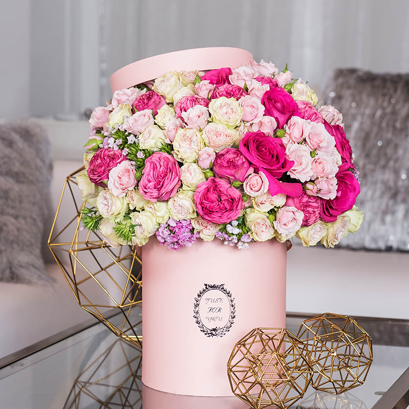 Rose Chapeau Rose Chapeau - A 10" tall hatbox that's overflowing with roses? Guaranteed to be enjoyed by all! Various shades and sizes of pink roses are accented with magenta dianthus flowers.