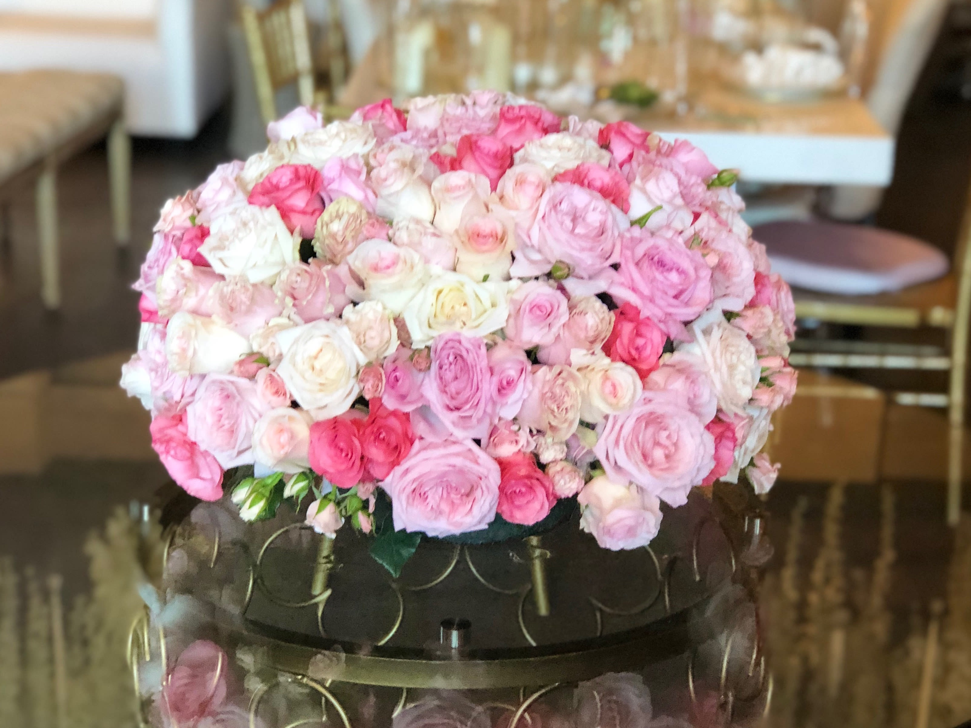 King's Ball - A luxurious pave of roses and spray roses! In various shades of pink and peach, this arrangement is a soft and beautiful display of nothing but roses.