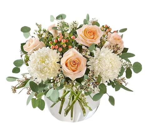 Peaches and Cream Bouquet Peaches and Cream Bouquet - This delightful design displays pretty peach & white blooms, loosely gathered inside a glass 6 inch bubble bowl with lush greenery draped all around.