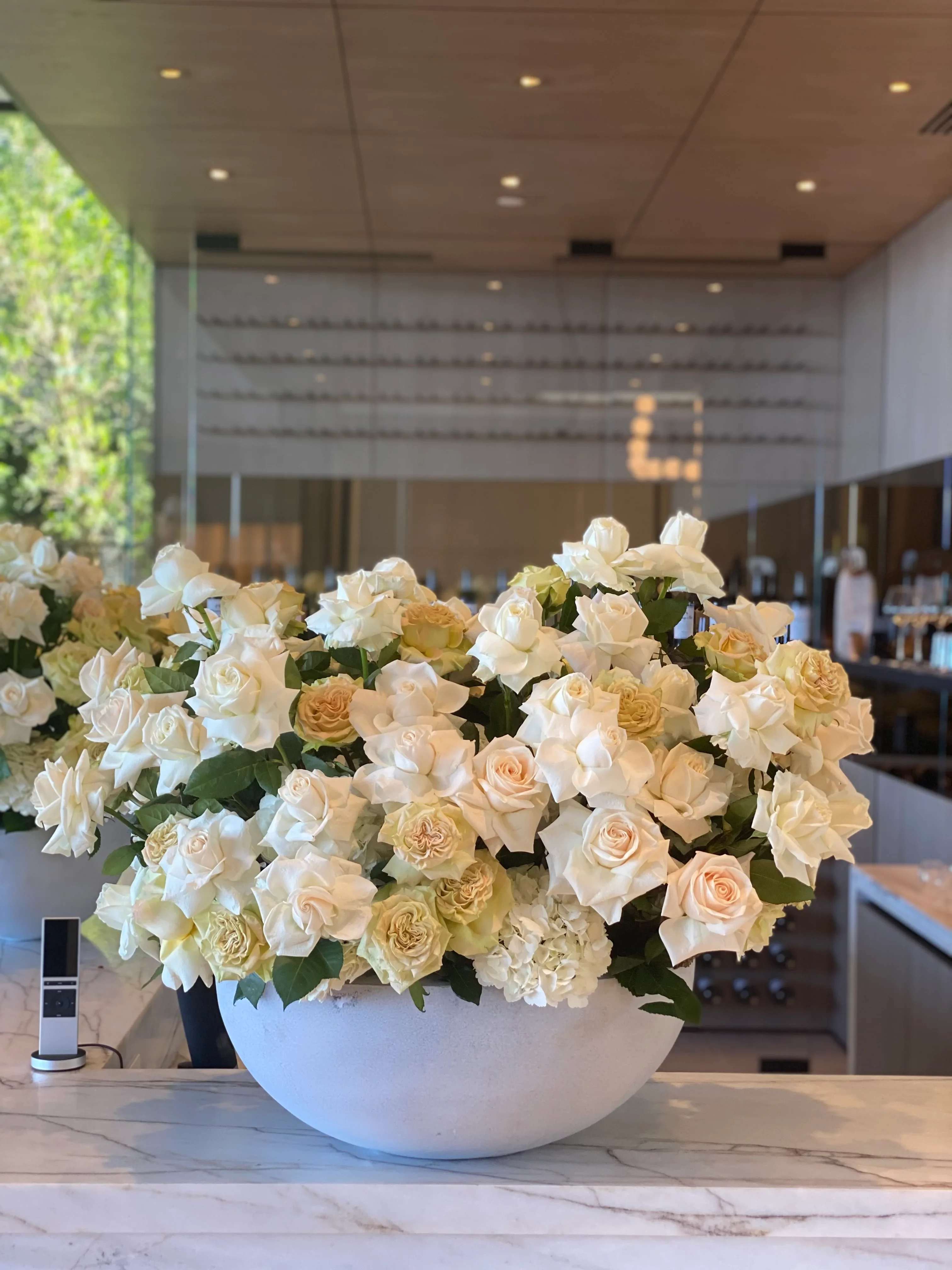 Noble - White and beige roses beautifully arranged in a gray vase, offering a modern and stylish floral display. Perfect for adding elegance to any space. 