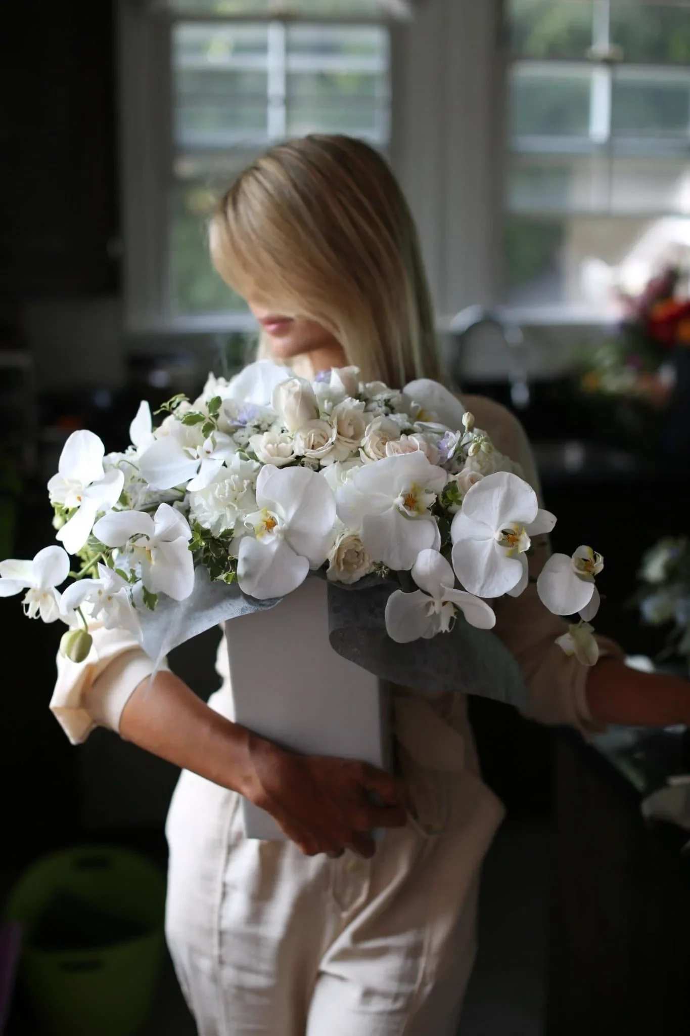 Nella - Nella is a stunning arrangement of white orchids mixed with white roses in a white vase. Perfect flower for sympathy and any special events, etc. 