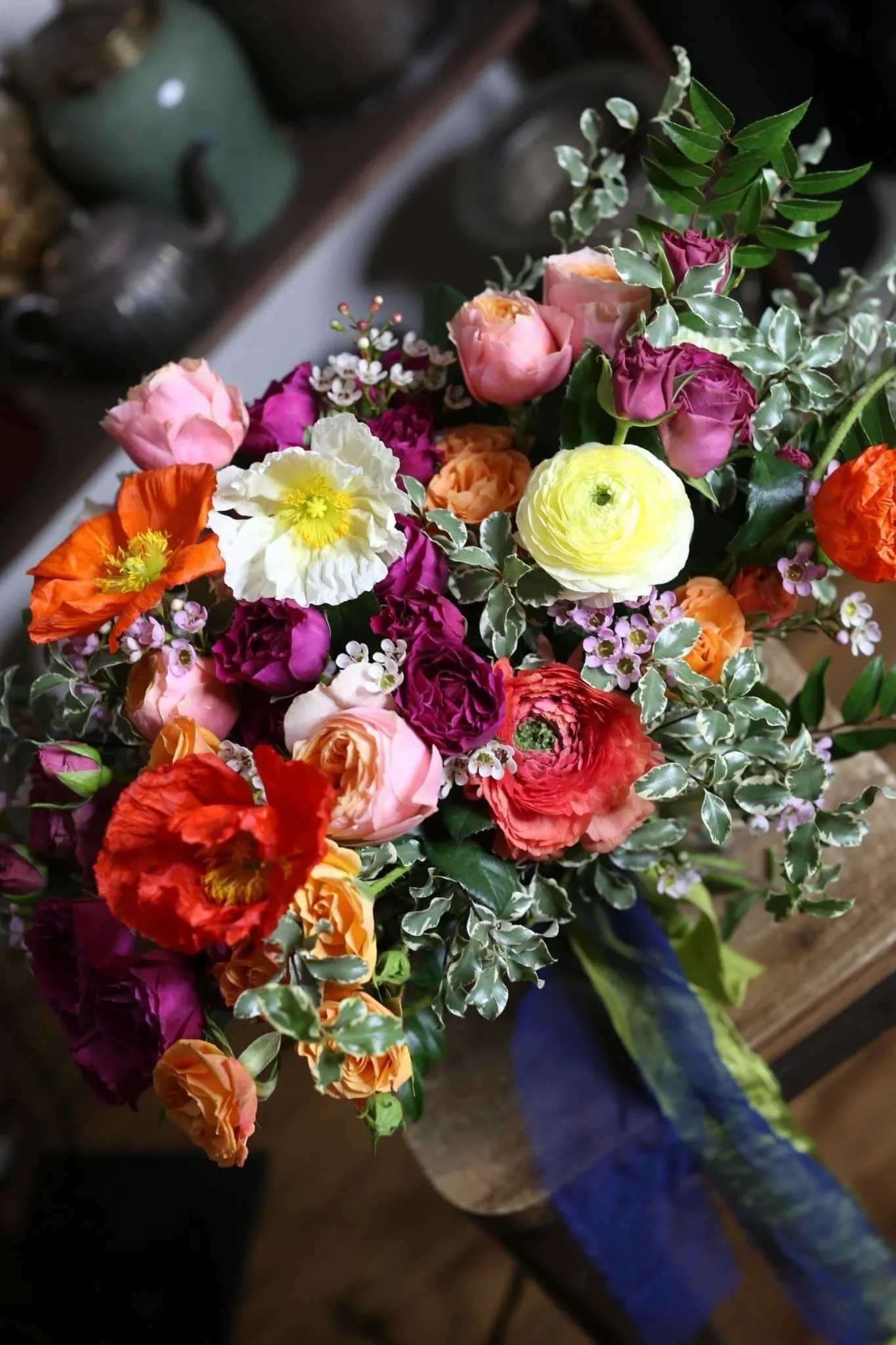 Alisa - Alisa is a vibrant flower arrangement with poppy flowers, orange roses, ranunculus, pink spray roses and greenery. This bright and colorful bouquet is a perfect birthday gift 