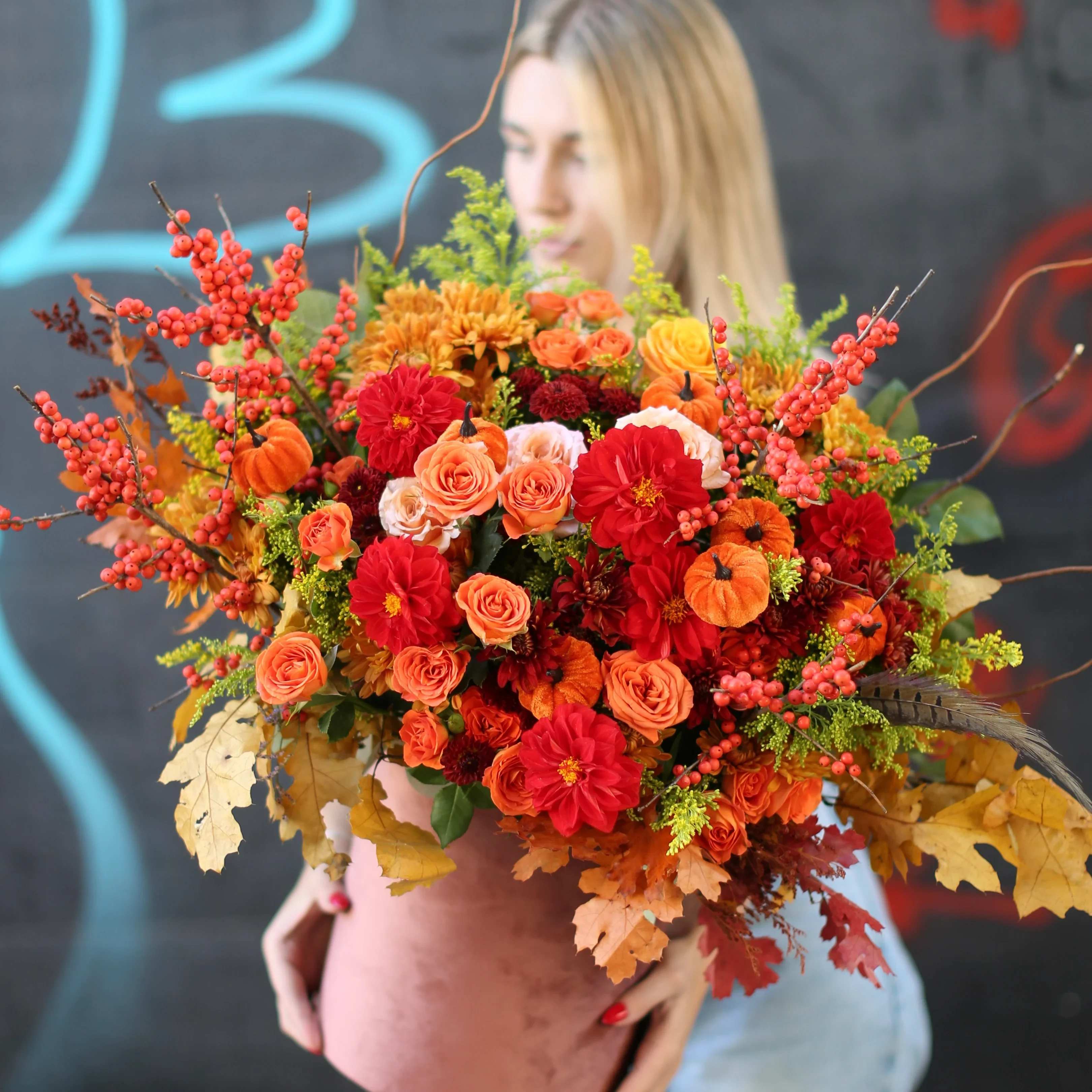 Sparks - Lush mix of red roses and orange roses, red dahlias, spray roses, berries, leaves and mini pumpkins, this large bouquet captures the essence of fall. Ideal for any seasonal gathering or as a warm, festive gift.