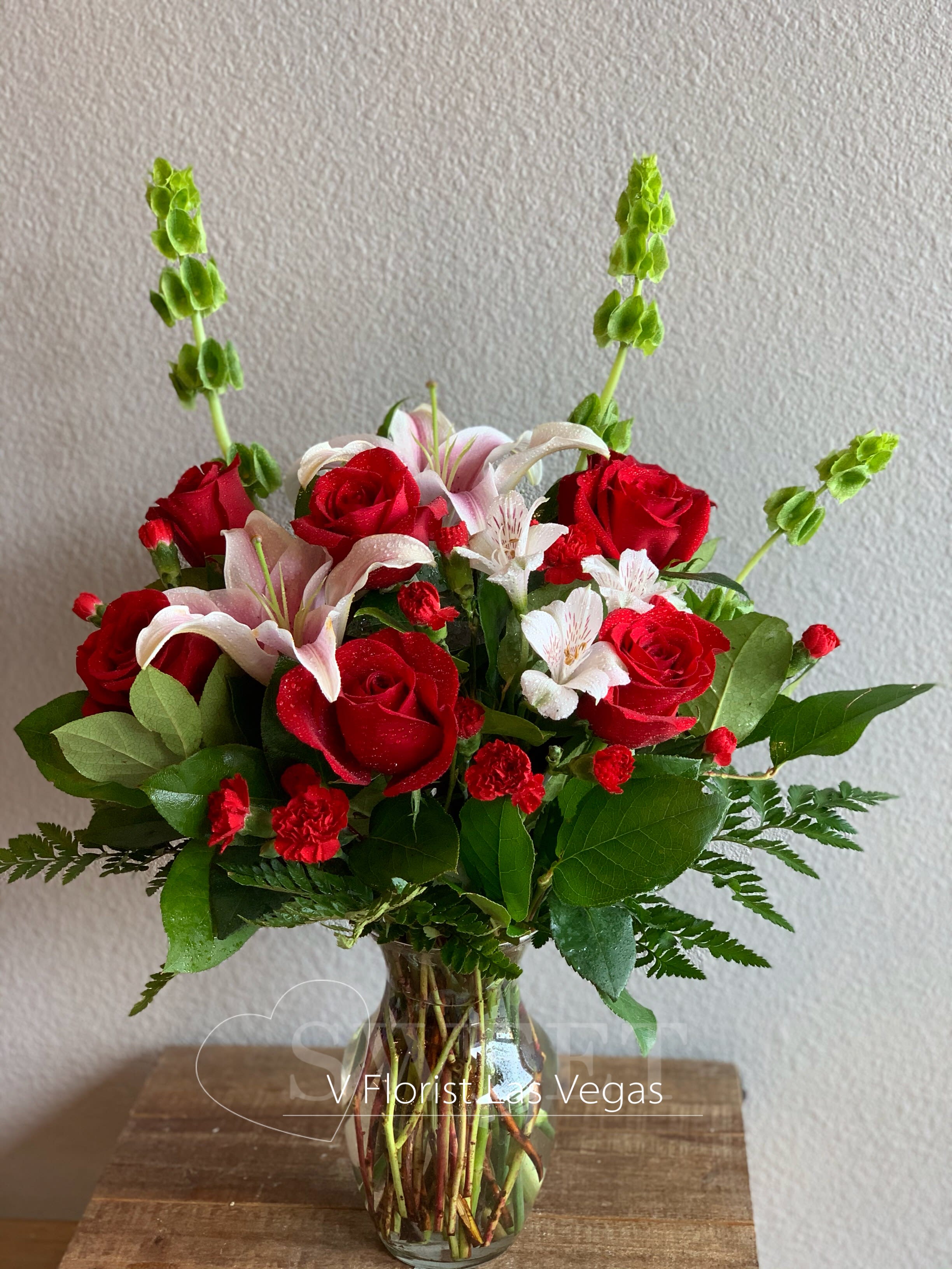 Valentine's Day Designer Choice Arrangement Valentine's Day Designer Choice Arrangement - Designer's choice of star fighter lilies, roses, and spray roses. Perfect to express the deep love to your love ones.