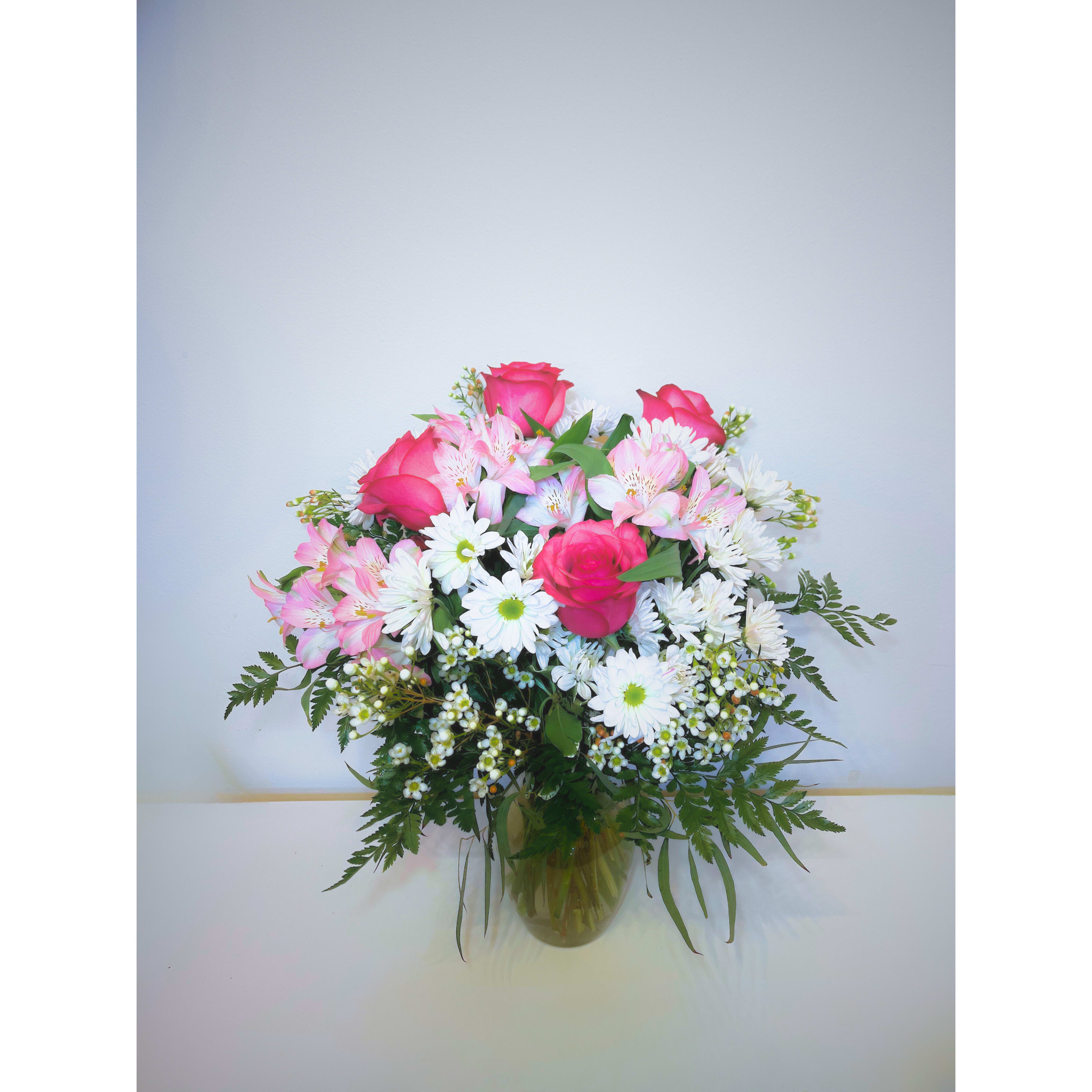 Cotton Candy Bloom - Soft and sweet like a cloud of cotton candy, this delightful arrangement features delicate pink roses paired with fresh white daisy mums. The perfect blend of charm and elegance, Cotton Candy Bloom brings a light, airy touch to any space. Ideal for celebrations, gifts, or simply adding a touch of beauty to your day. 