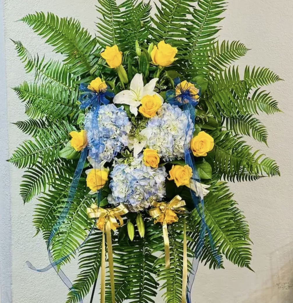 Blue and Yellow Spray - When someone so dear passes, a standing tribute is a fitting way to pay respects. Our impressive standing spray arrangement, meticulously handcrafted by expert florists (certified floral designers CFD) with pristine yellow and and rich blue hydrangeas, is a lush, full presentation that makes for a proud and respectful commemoration.