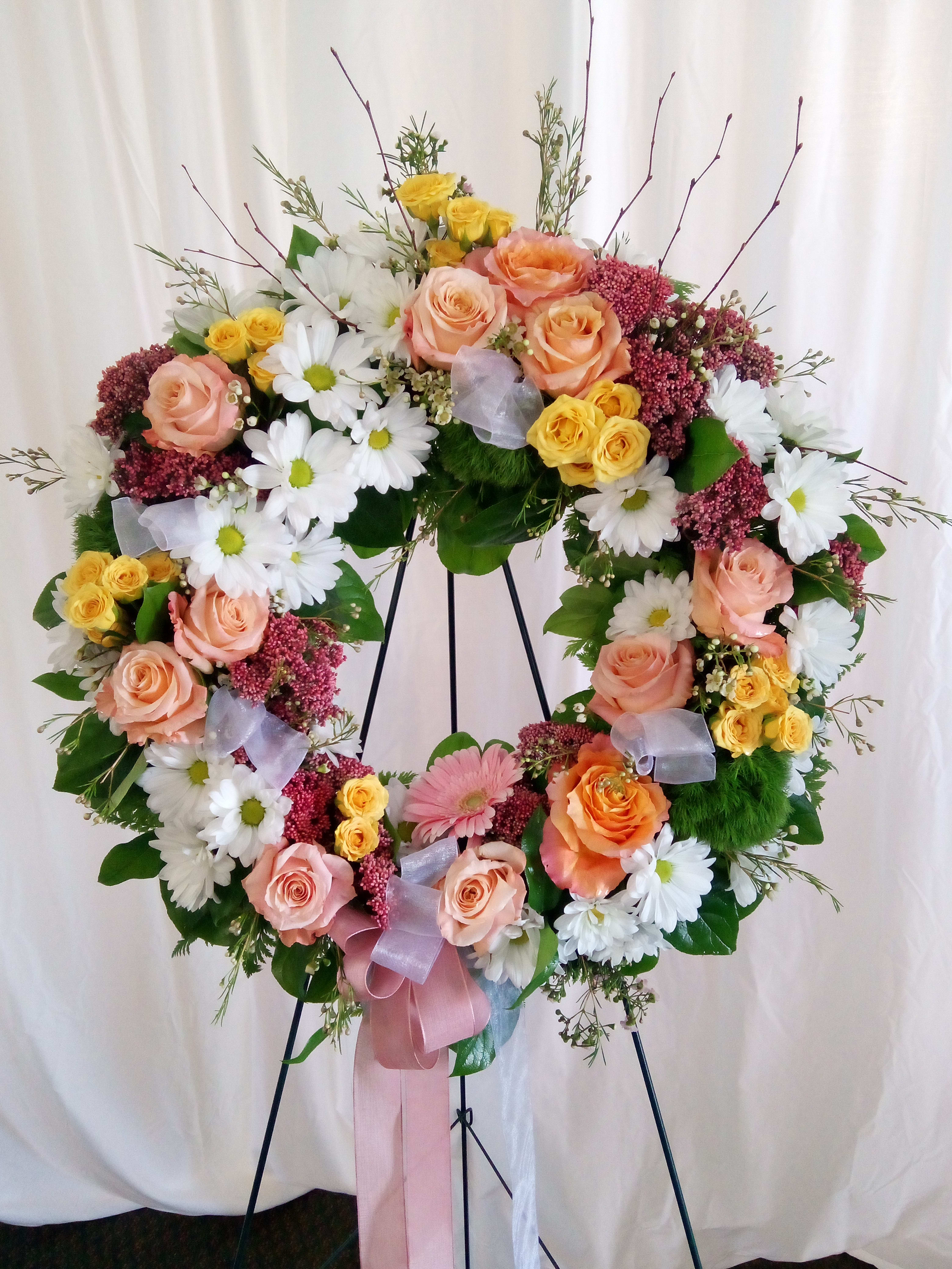 Halo  - A beautiful wreath made with an assortment of feminine colors and a bow.