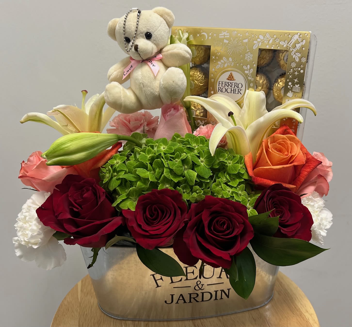 Small Bear, Chocolates, Roses arrangement - Metal vase with rose assortment, carnations, hydrangea (white or green), small lilies and ferrero rocher chocolates.
