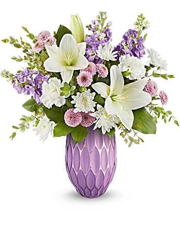 Lovely pastels - Celebrate Mother's Day in style with Teleflora's Lovely Pastels Bouquet, featuring a gorgeous lavender mercury-inspired sculpted glass vase filled with elegant white lilies, white carnations, lavender stock, and other beautiful blooms-a timeless and glamorous gift she'll adore.  Designed with elegance, Teleflora's Lovely Petals Bouquet showcases white Asiatic lilies, white carnations, lavender stock, lavender button spray chrysanthemums, white cushion spray chrysanthemums, and greens, artfully arranged in Teleflora's Pretty Glow vase.