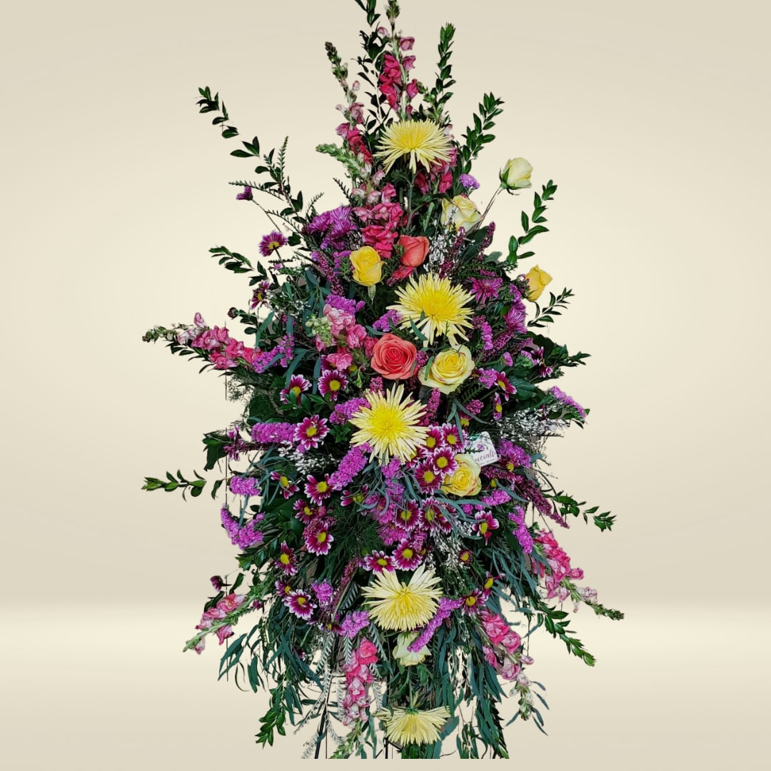 Celebration of Life - Honor a beautiful soul with our Celebration of Life Standing Spray — a bright and uplifting floral tribute created to reflect the love, joy, and unforgettable memories shared. This vibrant spray is designed with an eye-catching mix of pinks, oranges, yellows, and purples, symbolizing warmth, happiness, and a life well-celebrated. It's a heartfelt expression of sympathy and a beautiful way to bring comfort and light to those gathered.  Sympathy flowers have long played an important role in offering support during times of grief. They serve as a visual reminder of the love and community surrounding those in mourning and can bring peace and healing simply through their natural beauty. A standing spray like this one makes a bold and respectful statement, standing tall and proud near the casket or at the front of the service.  At Specialty Floral Design, we understand how meaningful it is to honor a loved one with flowers that reflect their personality and the life they lived. As your local florist in Olympia, WA, we handcraft every sympathy arrangement with care and attention to detail.  We offer delivery to all local funeral homes, including: - Woodlawn Funeral Home - Alternatives Funeral &amp; Cremation Services - Mills &amp; Mills Funeral Home  We also serve the surrounding areas, including Tumwater and Lacey, WA.  Let us help you share your compassion and memories through a floral arrangement designed to celebrate life and love.      