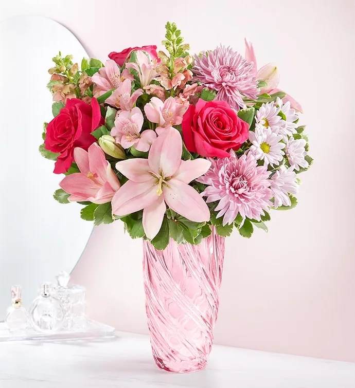 Simply Pink -  A simply beautiful way to connect with the ones you care about. Featuring a mix of blooms in shades of pink and lavender, it’s designed in our keepsake vase with a spiral design, celebrating the beauty of Depression era pressed glass. 