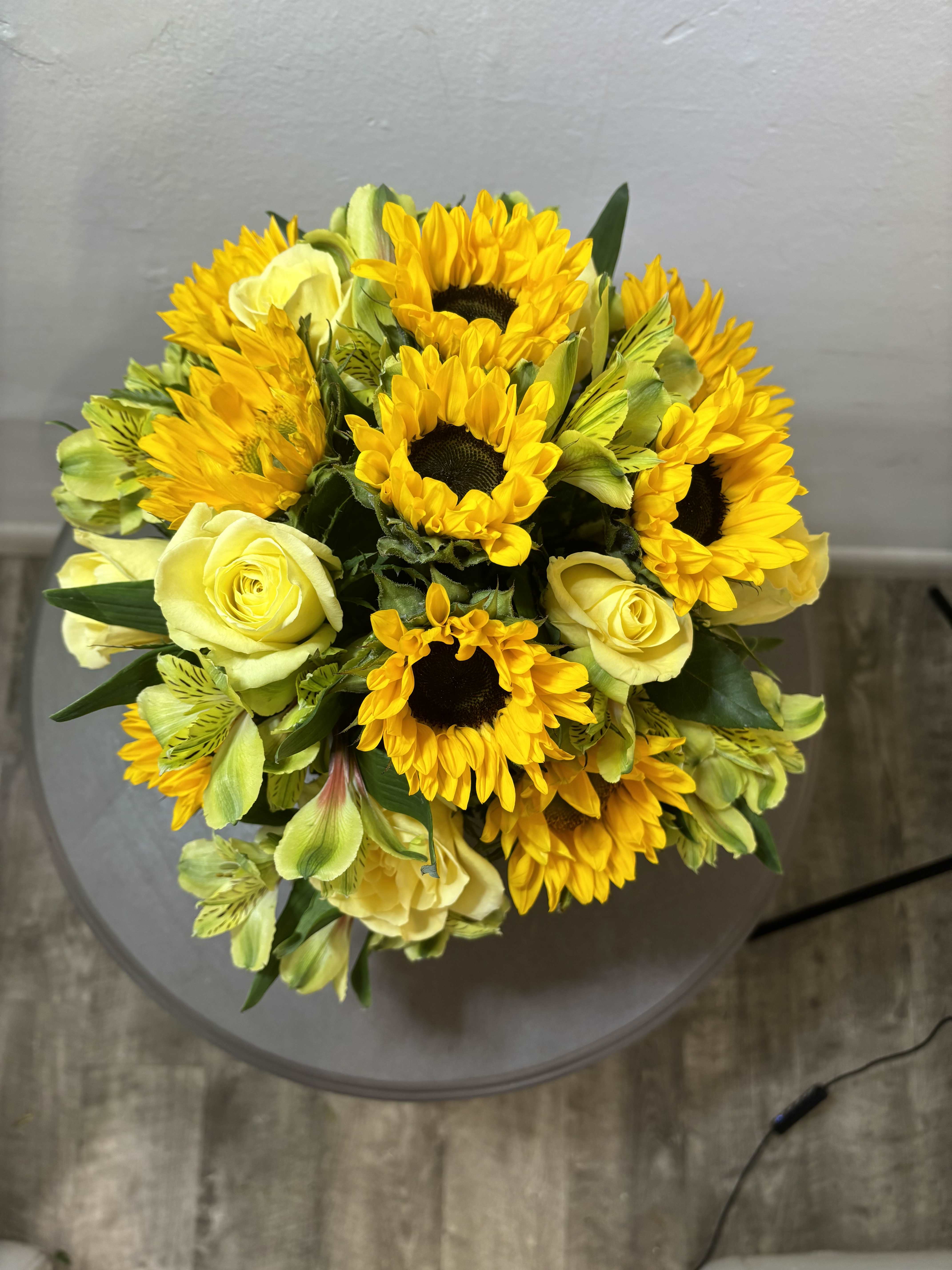 Sunny Sunflowers  - The sun is pretty great, but sunflowers are the greatest. Let’s prove it. The sun keeps us warm, we’ll admit it, but sunflowers never make us sweat. The sun gives us the daytime, which we appreciate, but sunflowers don’t go away for 12 hours per day day. Sunflowers, unlike the sun, know that would be rude. Finally, the sun gives us a nice tan once in awhile, but sunflowers have never given anyone a sunburn. This autumn, let sunflowers enhance your life, or the life of a loved one, with this Sunny Sunflower arrangement! You will not regret it.
