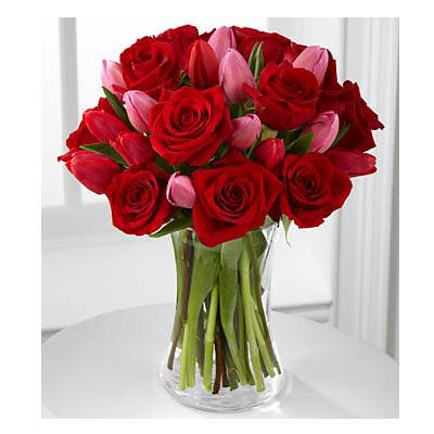 Let Love In Let Love In - speaks of romantic moments through rich color and fresh dazzling blooms. Our finest red roses mingle with bright red and popping pink tulips picked fresh from the farm to create the perfect way to win their heart this coming Valentine's Day. BEST bouquet includes 22 stems with vase and Heart pick that reads Happy Valentine's Day. Bouquet is approximately 16"H x 13"W.