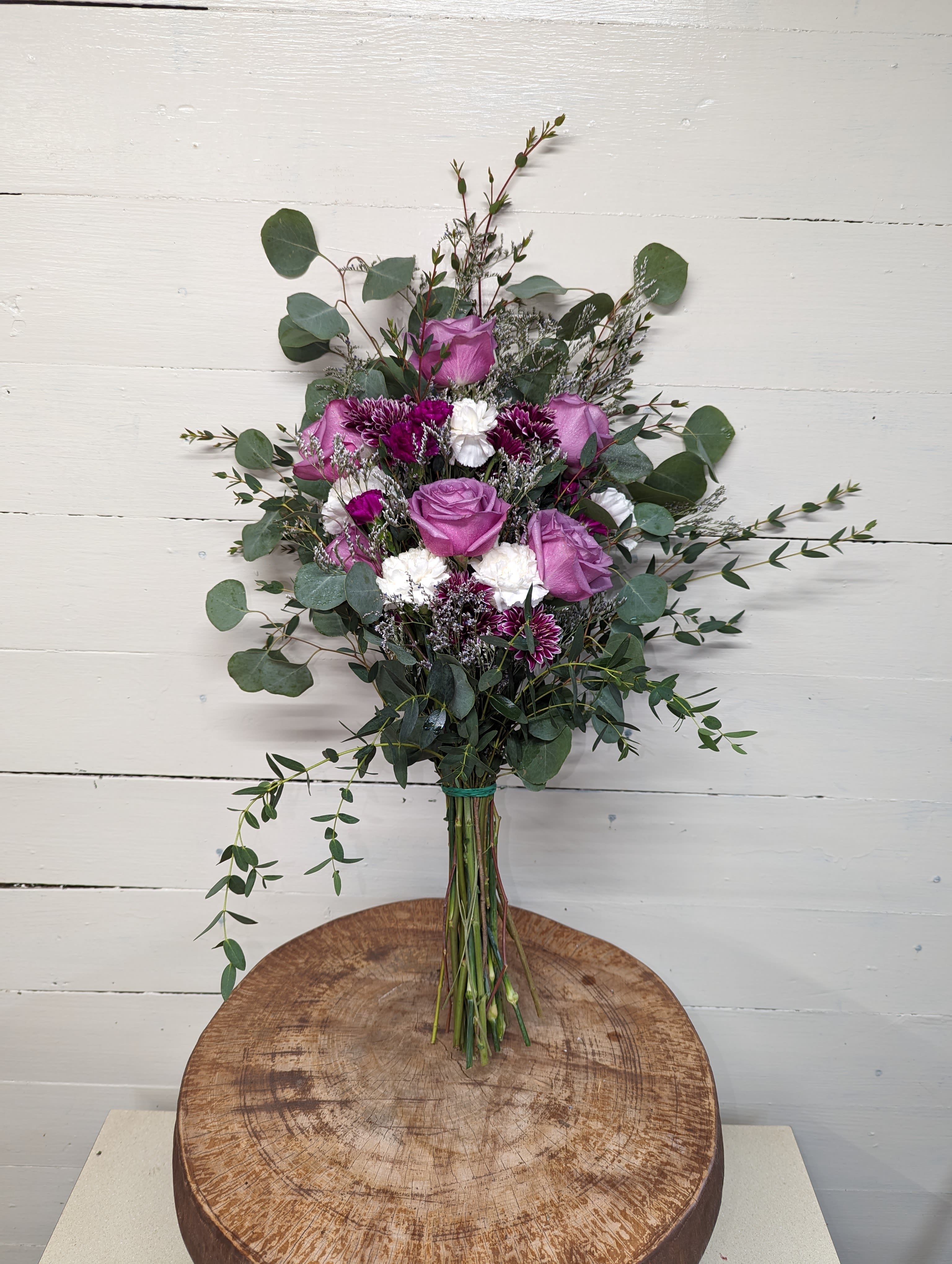 Fresh Floral Wrapped Bouquet - A quality selection of seasonal blooms wrapped in cellophane and finished with a matching bow. Perfect as a surprise for friends, family or someone special. Requests for specific color schemes and flowers available. 