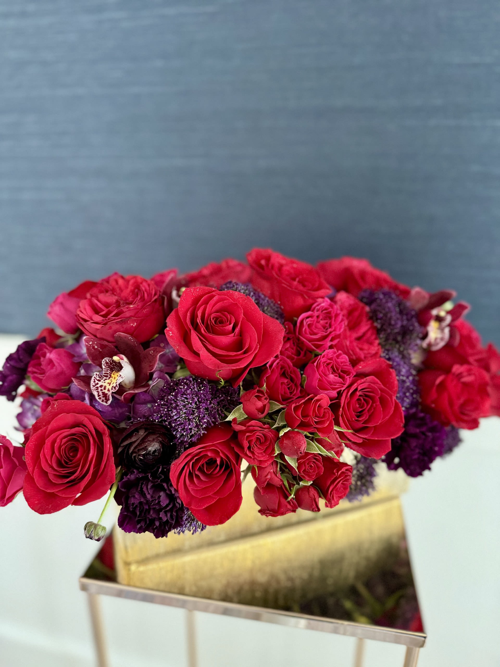 Red  - Low and long arrangements with a mix of red, purple and deep moody hues. 