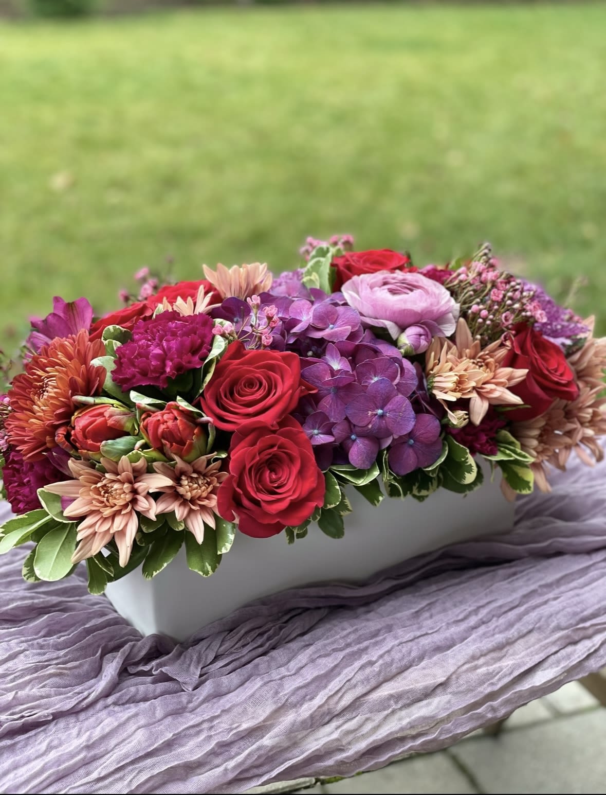 Ruby - A blend of jewel tone fall flowers to brighten any setting.
