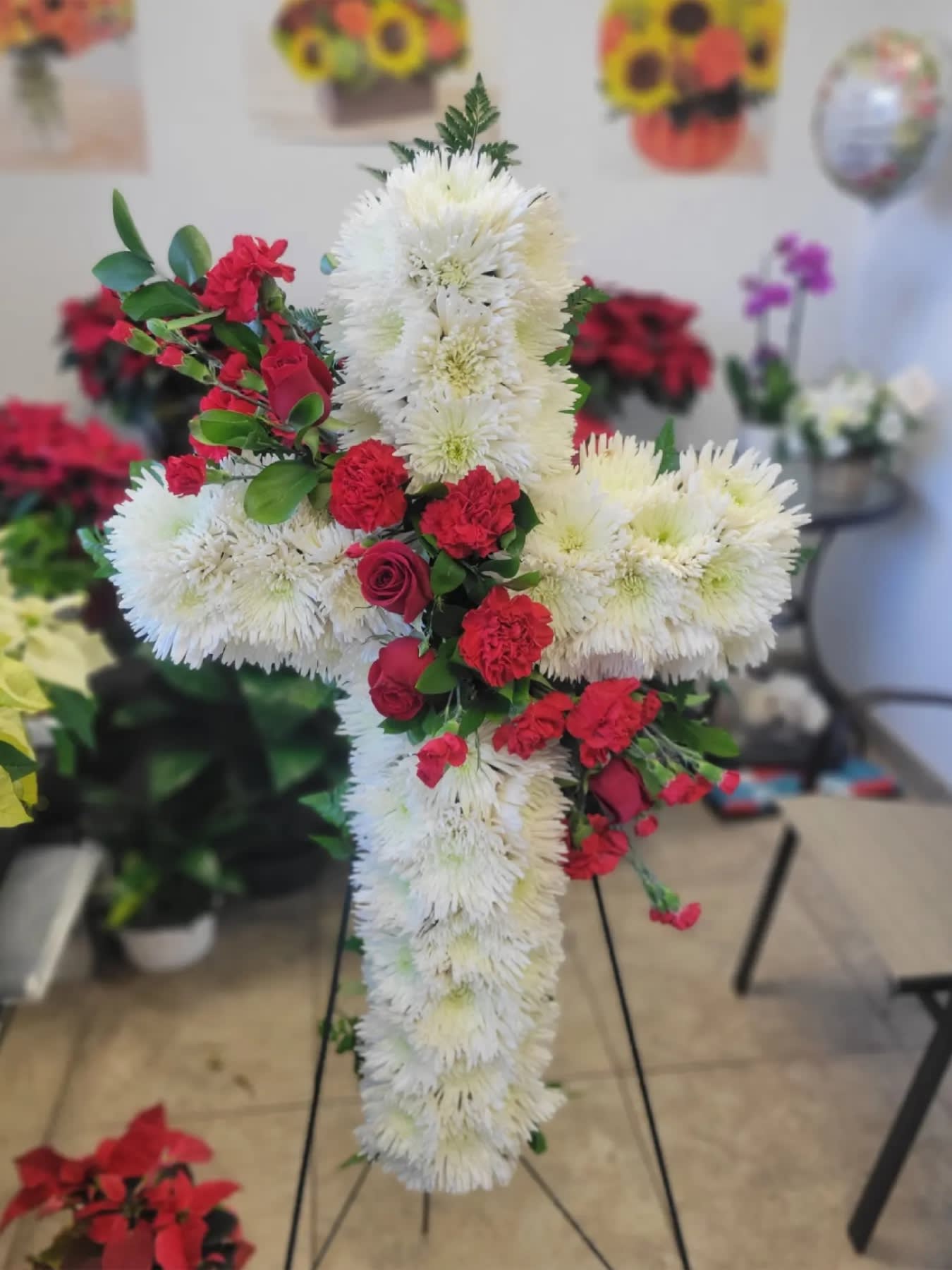 Ethernal Cross - a 22' cross with white spider and red roses in stand  Flowers and similar colors