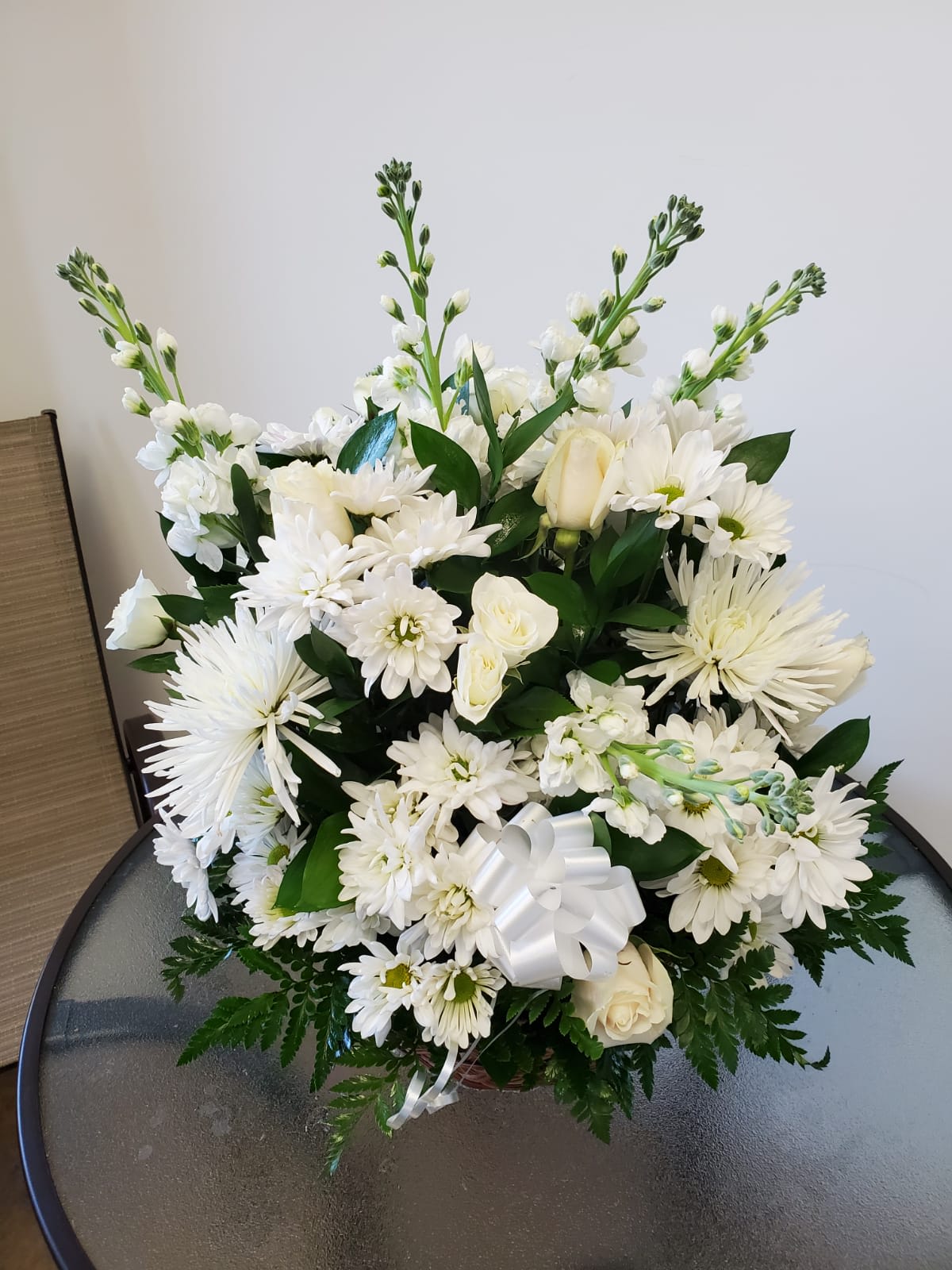 Heartfelt Condolences - An all white arrangement Daisy roses stock spray roses white and green rusgus and leatherleaf  Flowers and similar colors