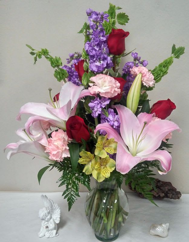 My Sweet Pastel - Red roses, lavender stock, yellow alstromeria, bells of ireland, lilies and carnations make this lovely recycled glass vase work.